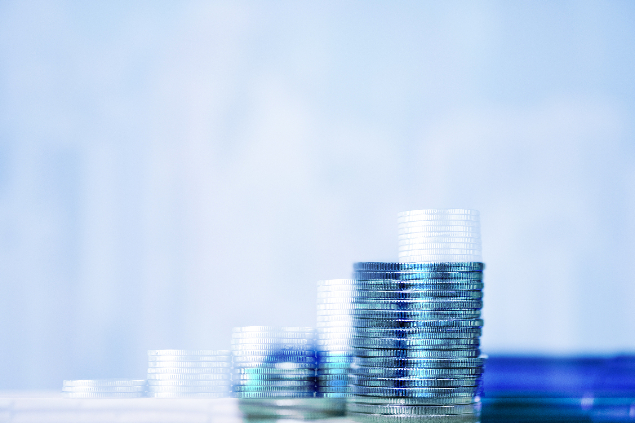 double exposure of stacks of coins and account book or credit ca
