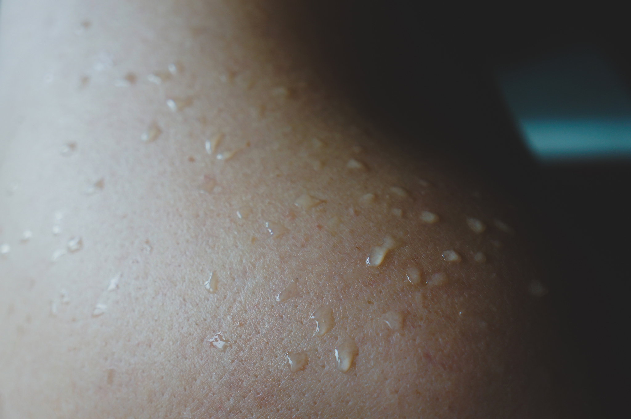 female shoulder with water drops
