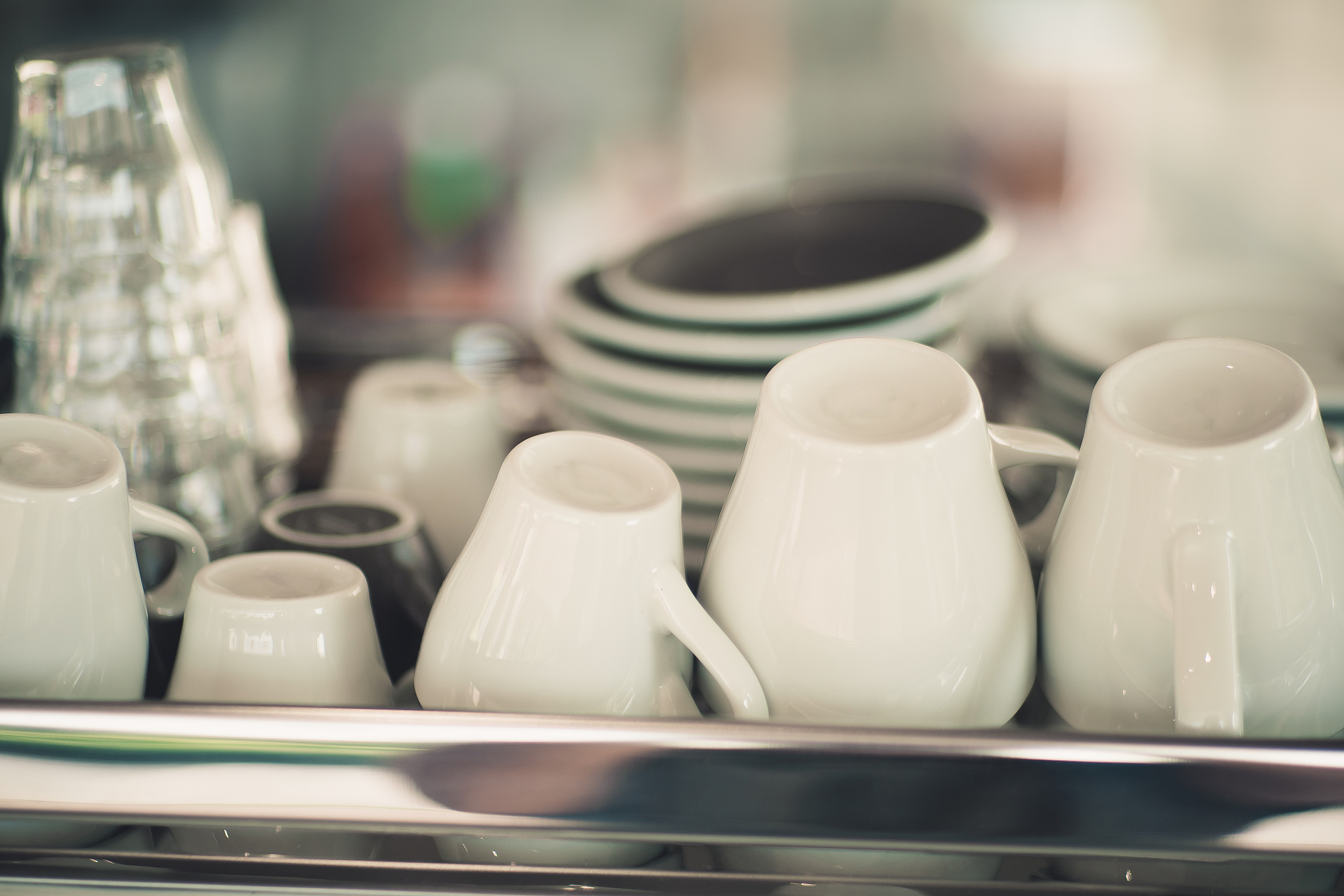 white coffee cups are placed on top of the coffee machine.