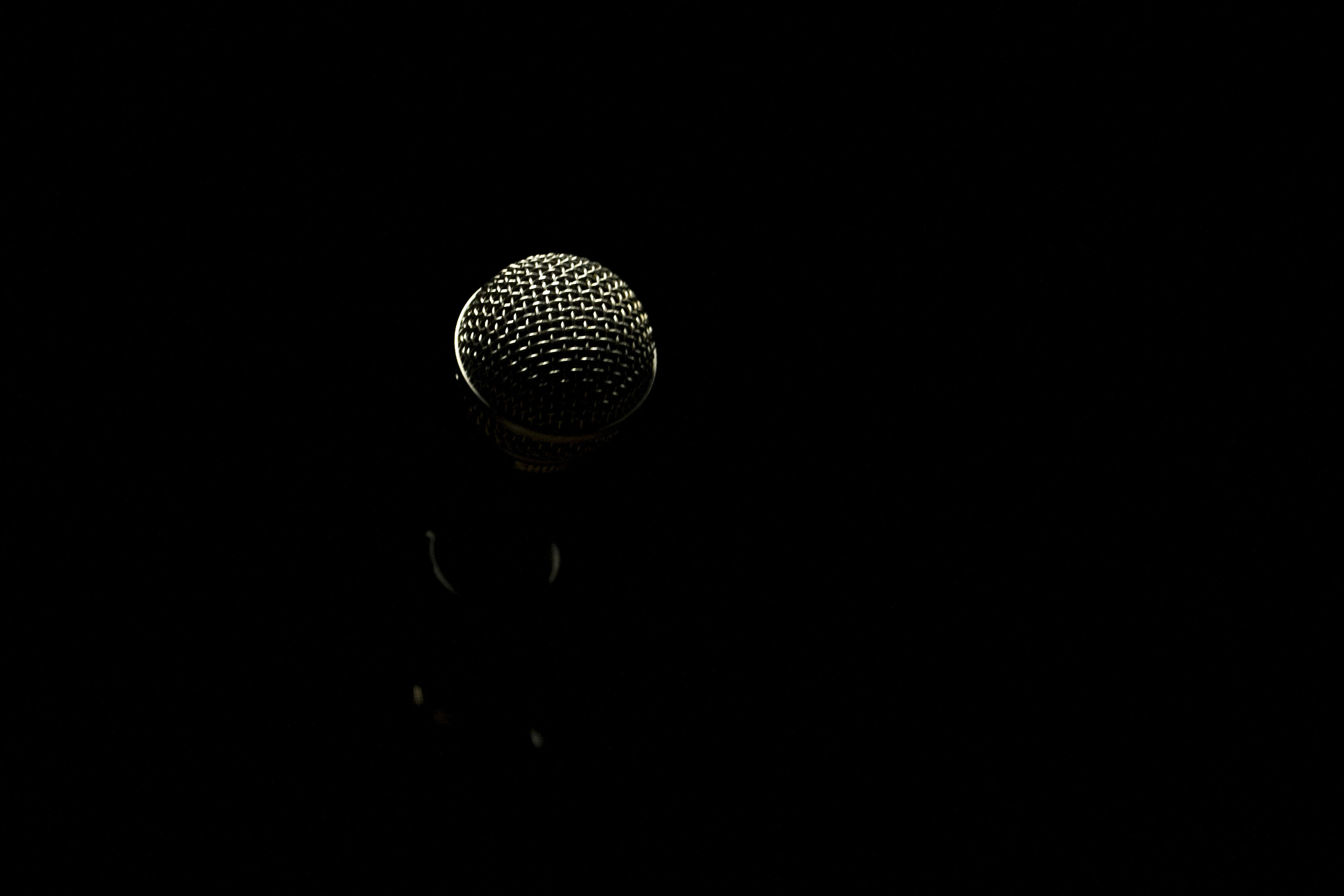 close-up of microphone against black background