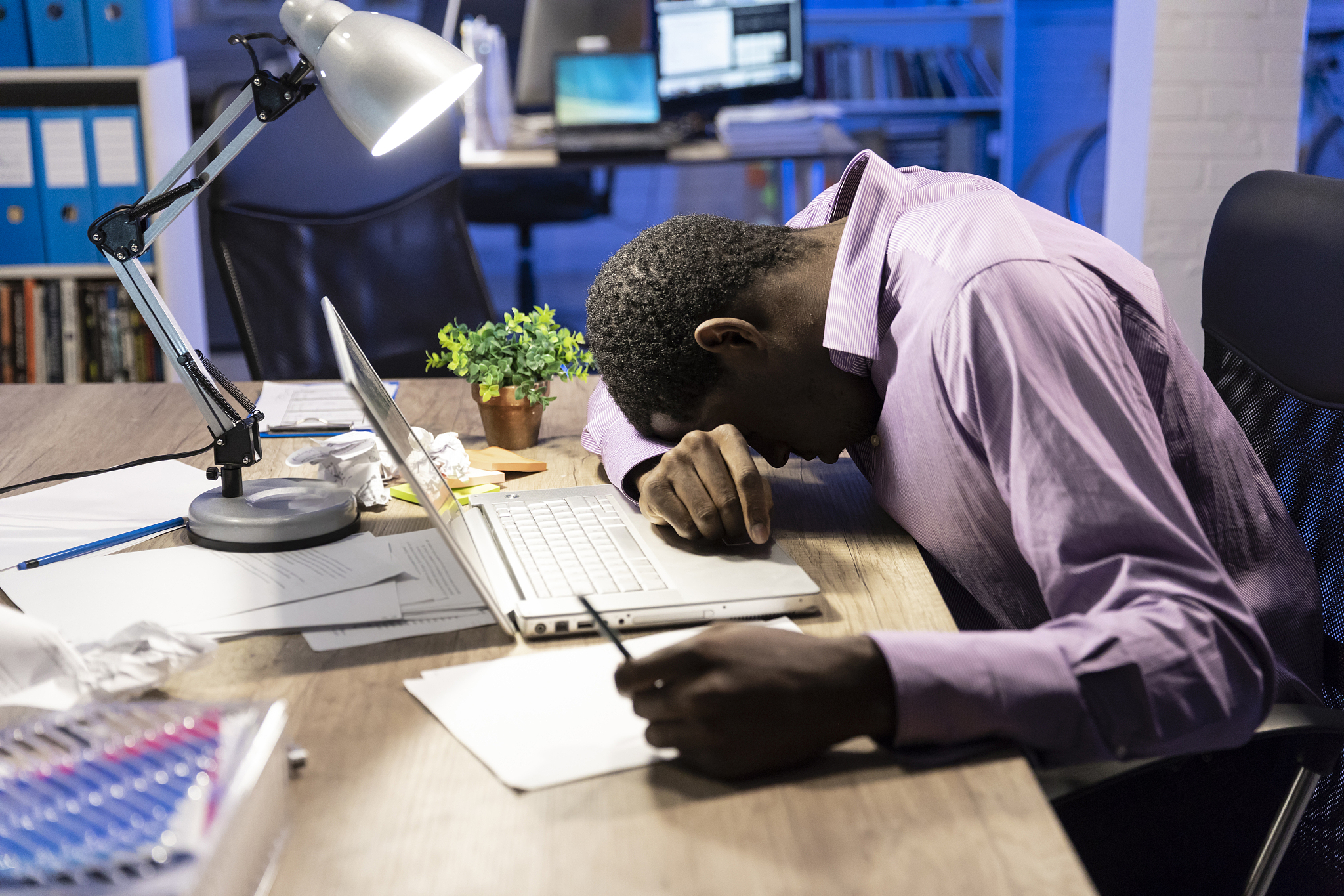 businessman working late, sleeping on desk