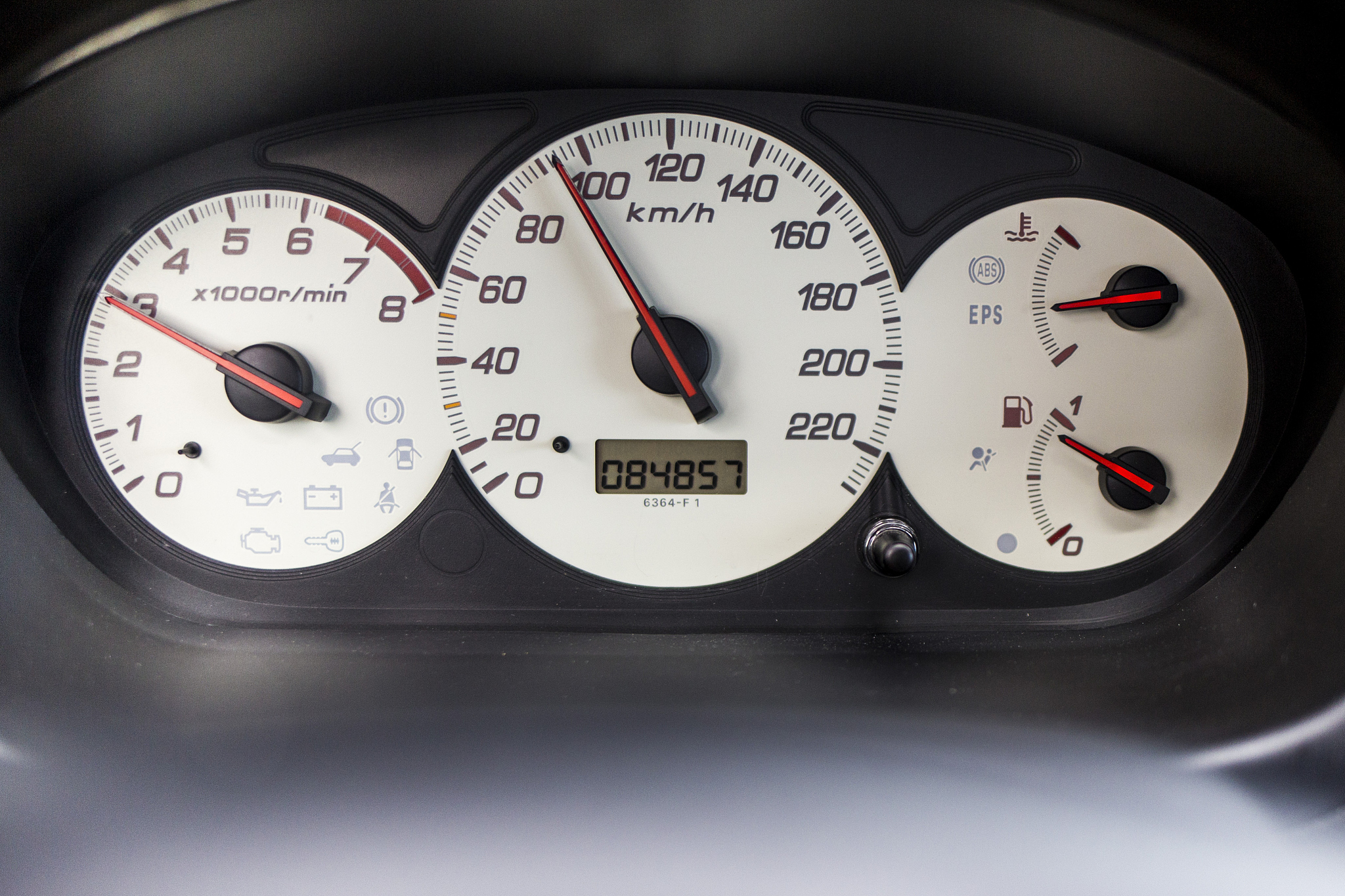 white odometer cockpit car on black background
