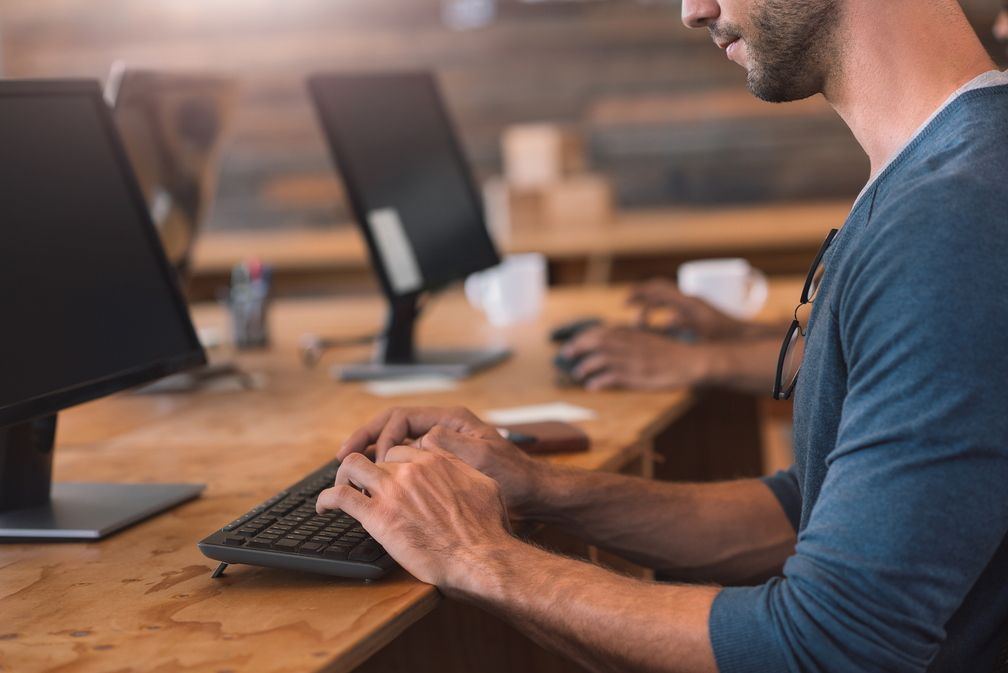 young businessman working on a computer in an office table