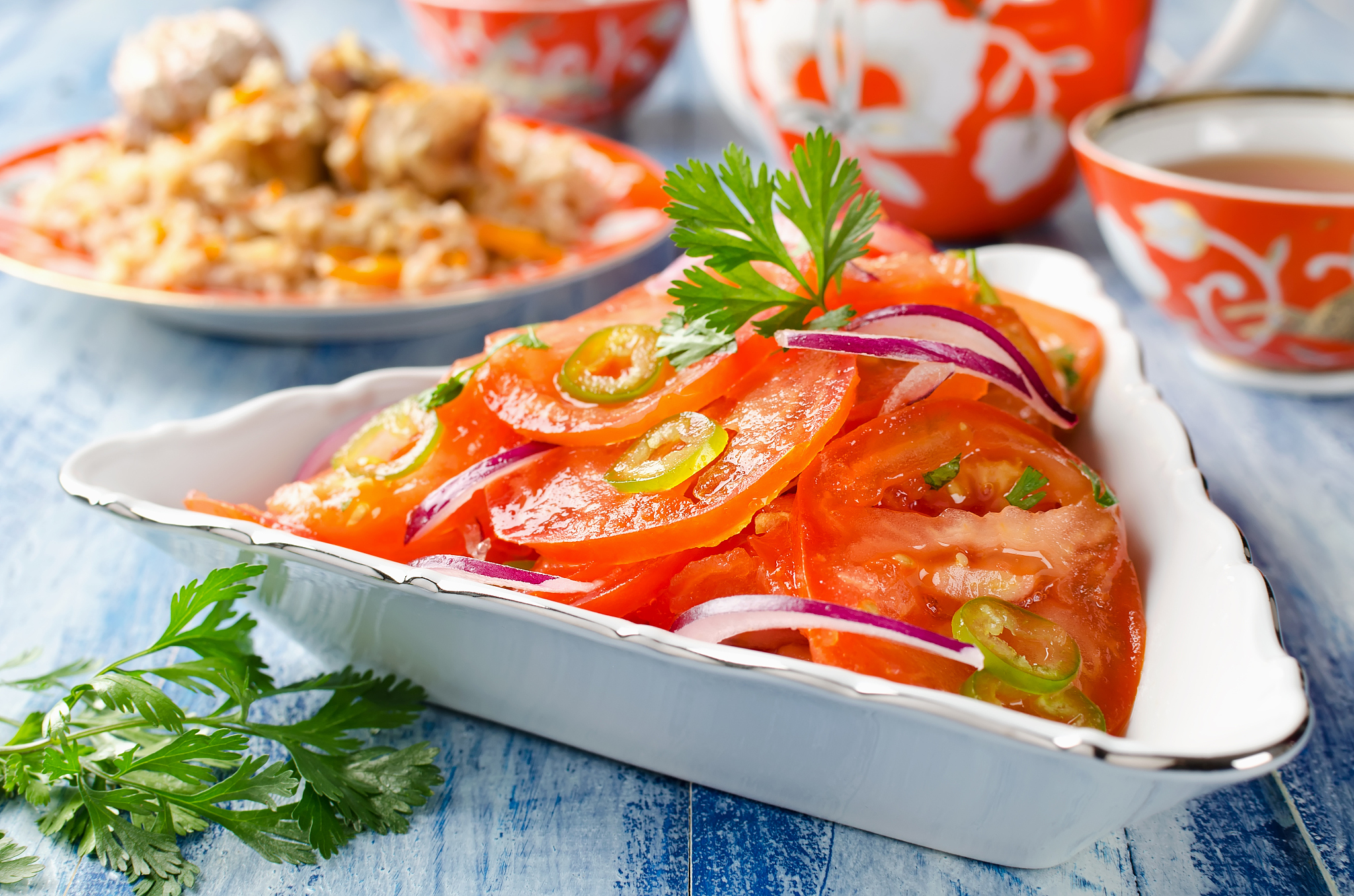 vegetable salad from tomatoes with onions and hot peppers