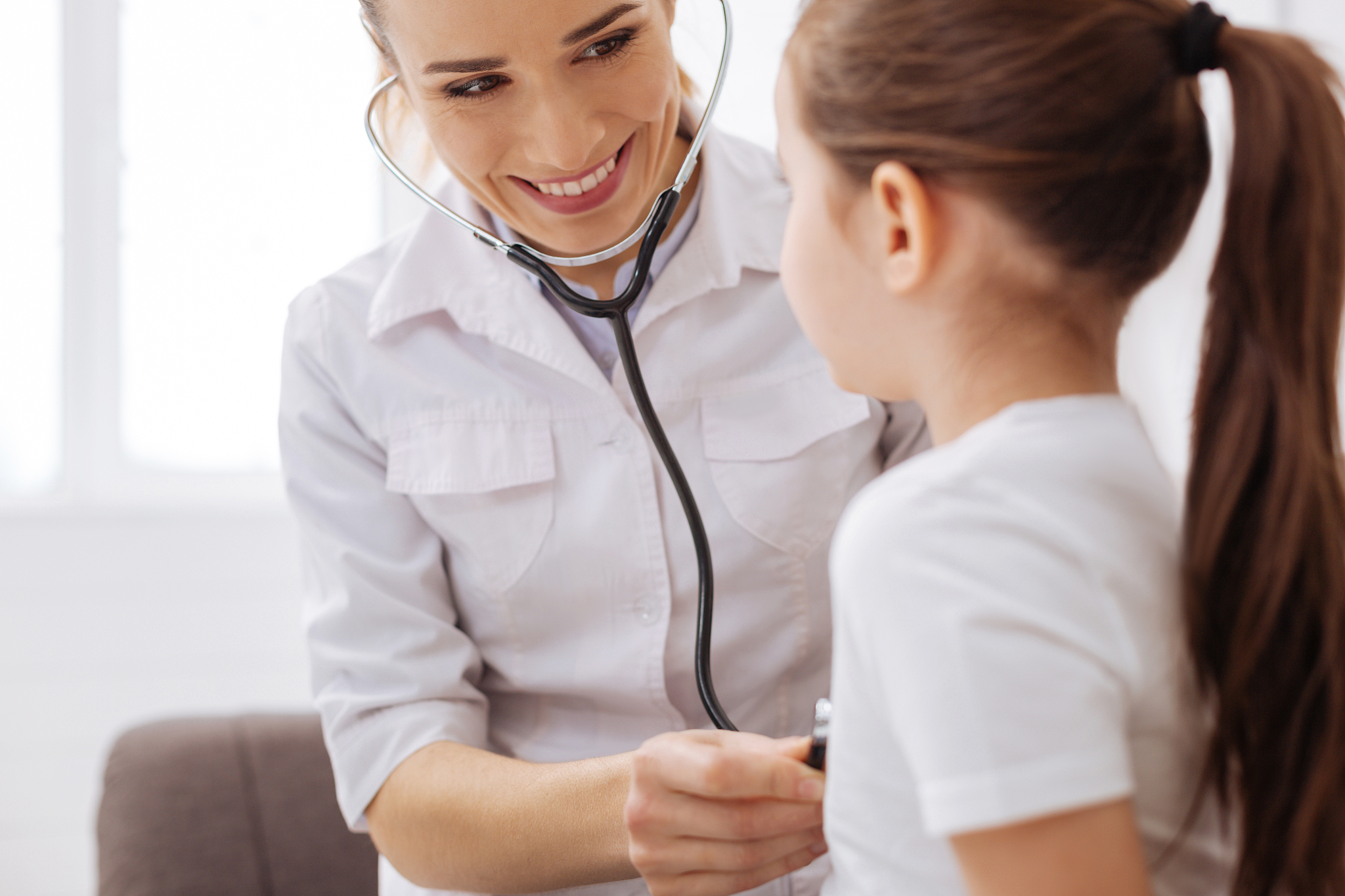 sweet trained doctor consulting her little patient