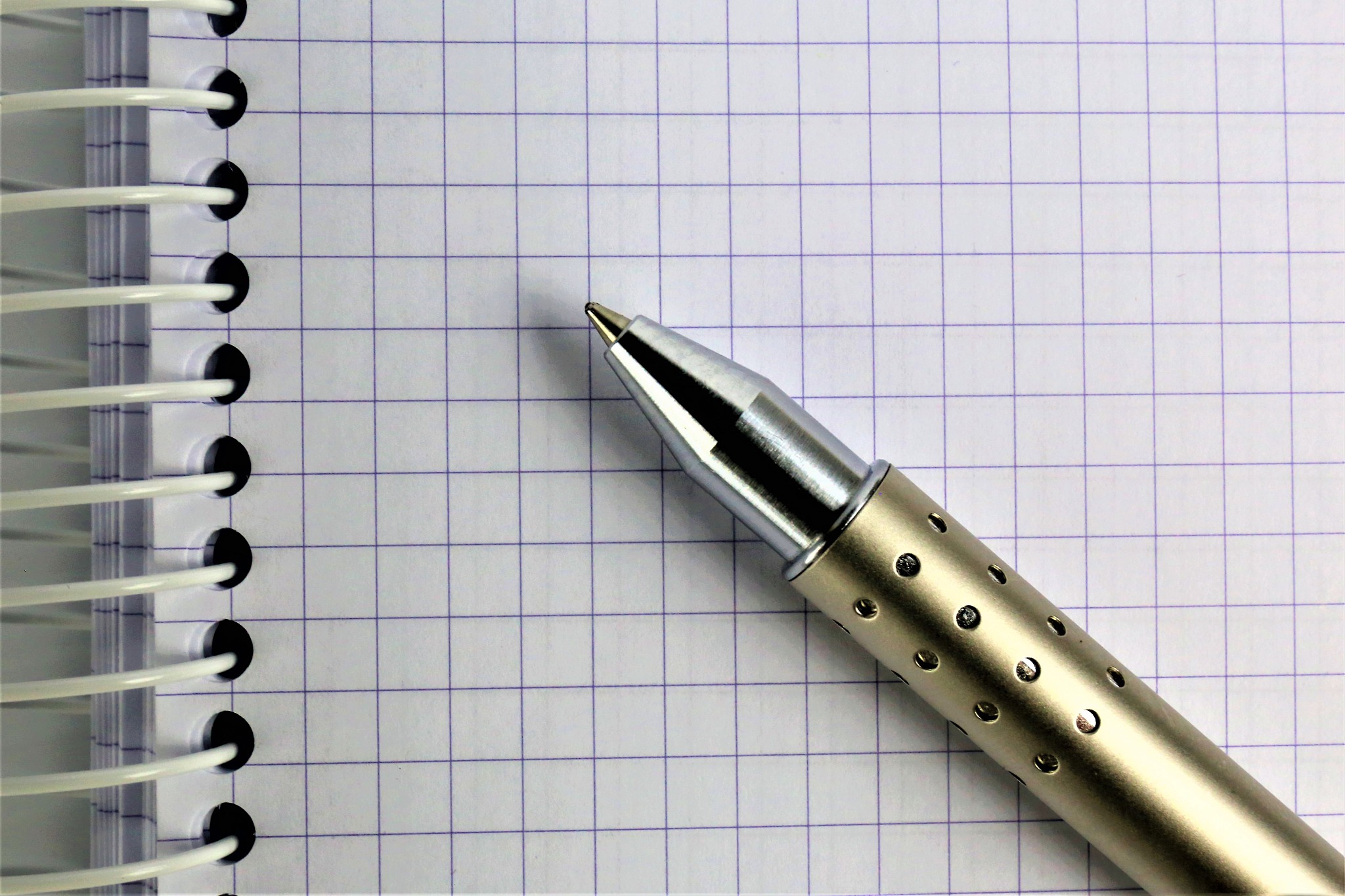 an concept image of a spiral notebook with a pen and copy space