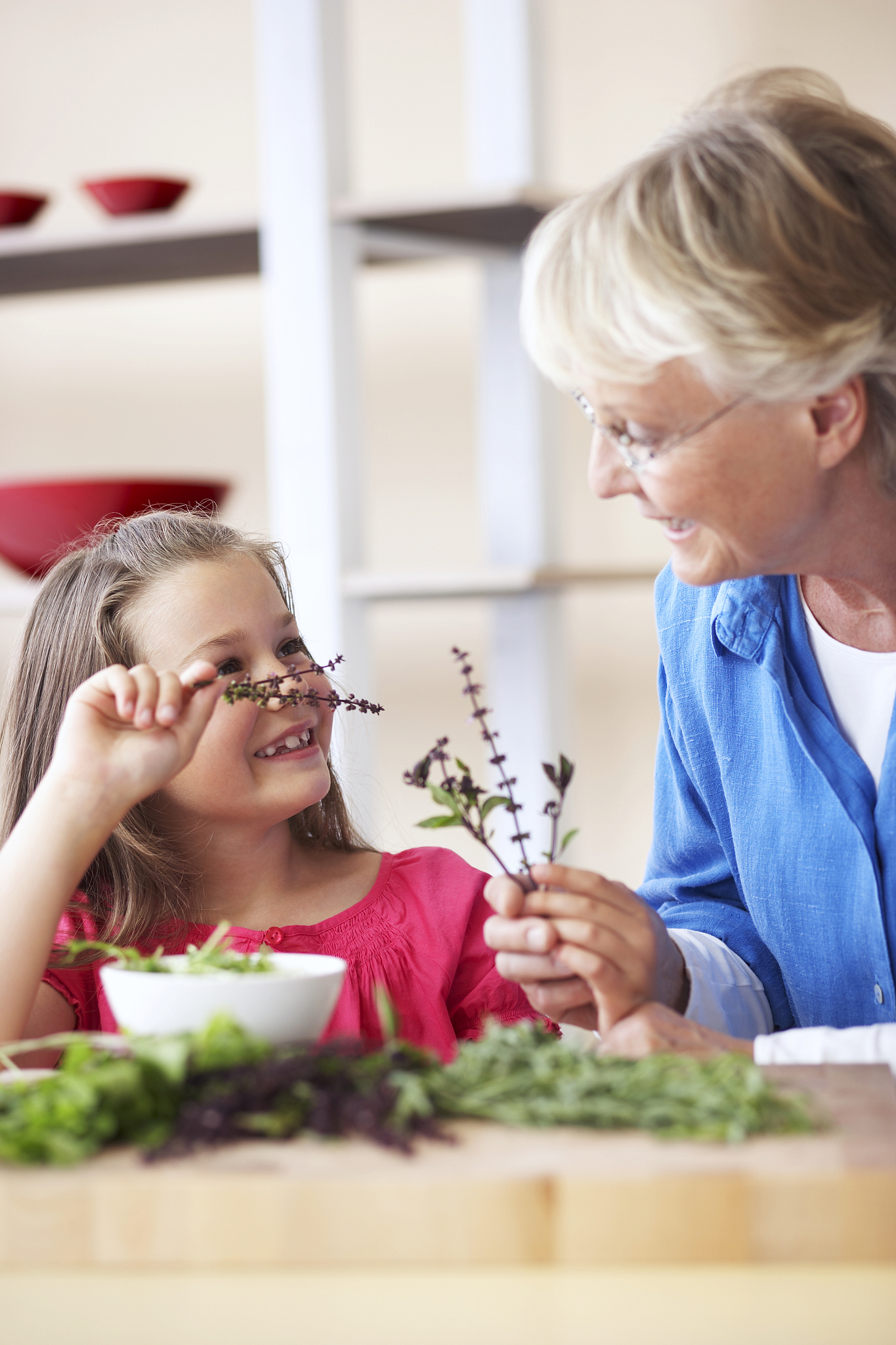 girl (7-9) holding dried flowers with grandmother