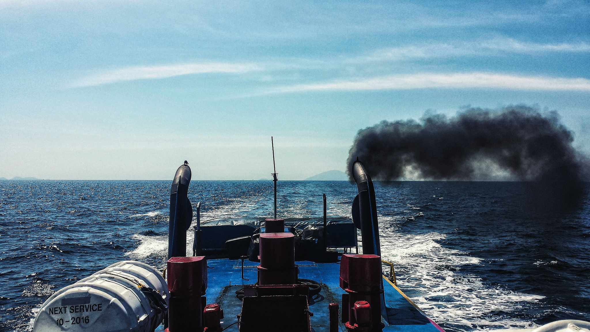 smoke emitting from boat while sailing in sea