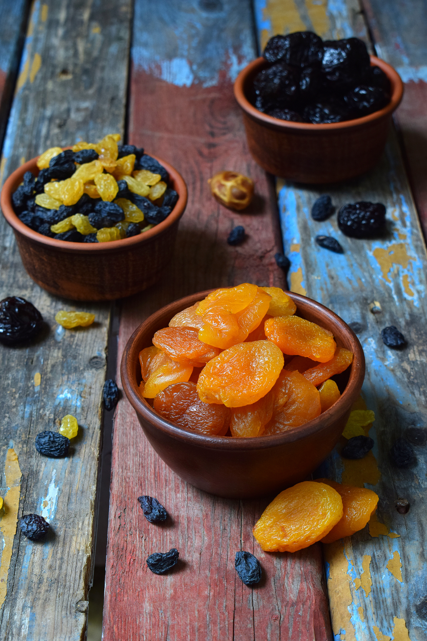 mix of different varieties of dried fruits on wooden background 