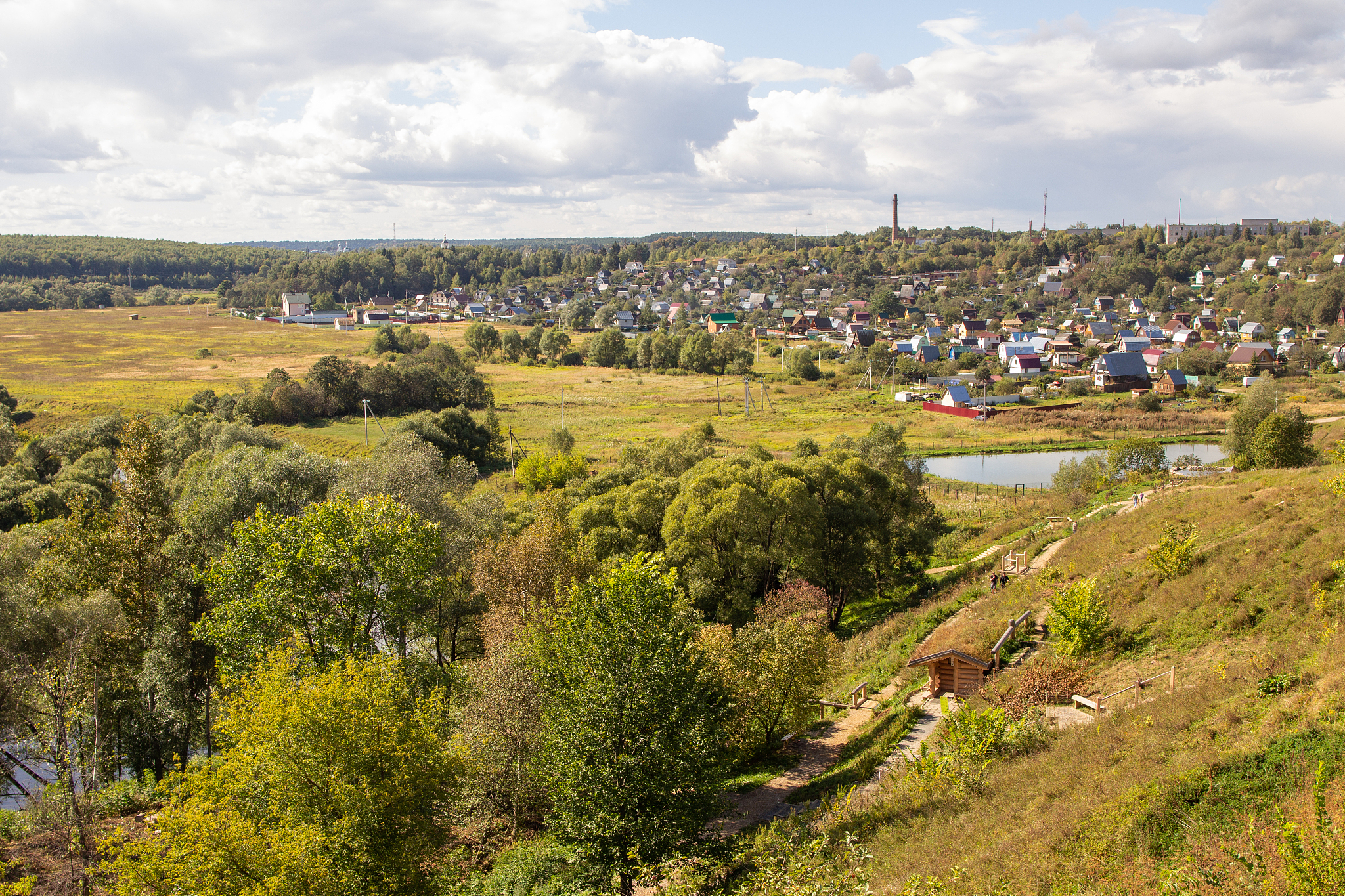 russian landscape with fields, meadows and a village and skyline