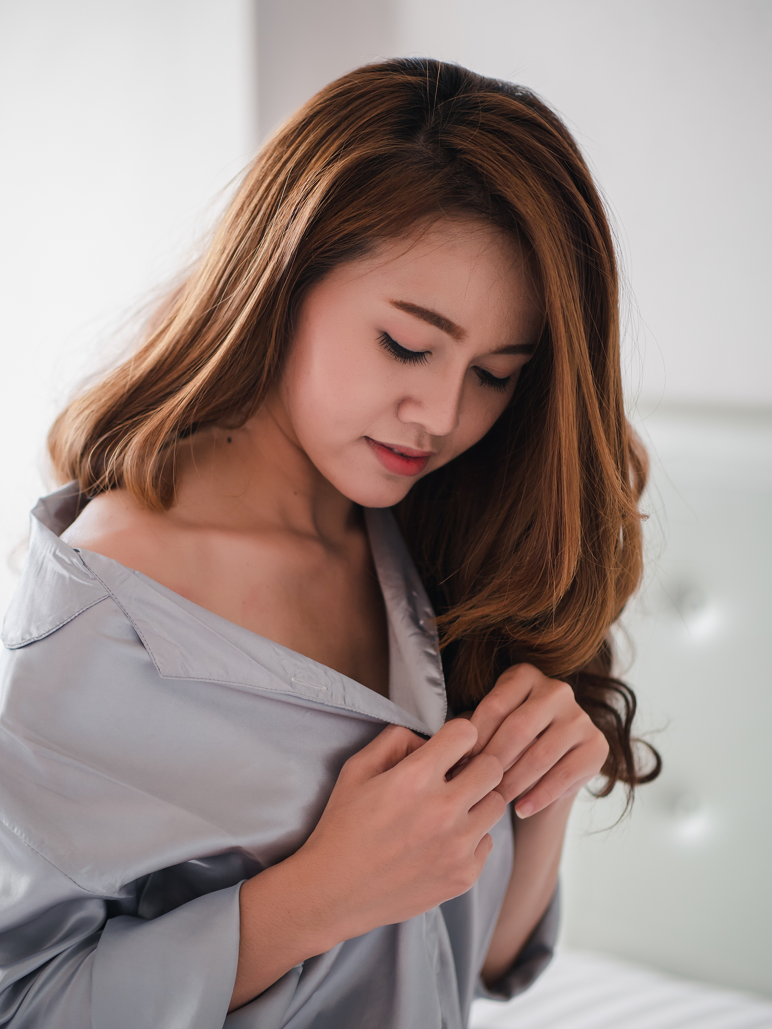 happy beautiful asian woman in sleepwear at home in the morning 