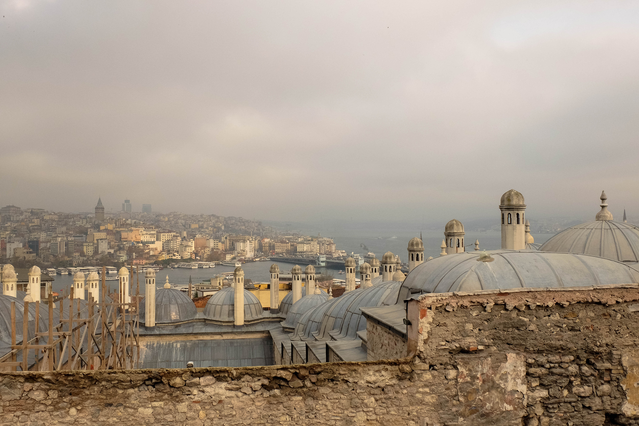 cityscape by river against cloudy sky