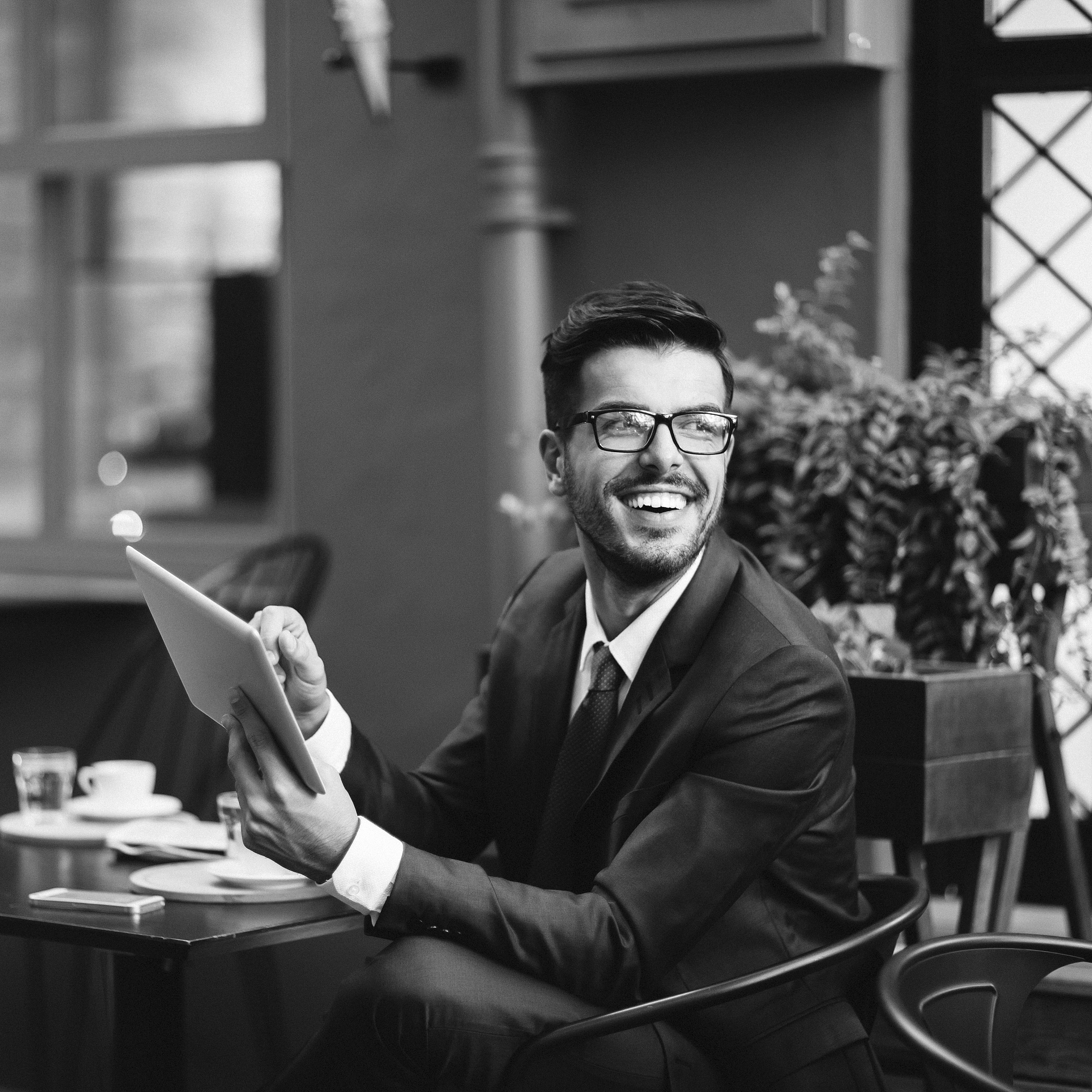 businessman with tablet at cafe