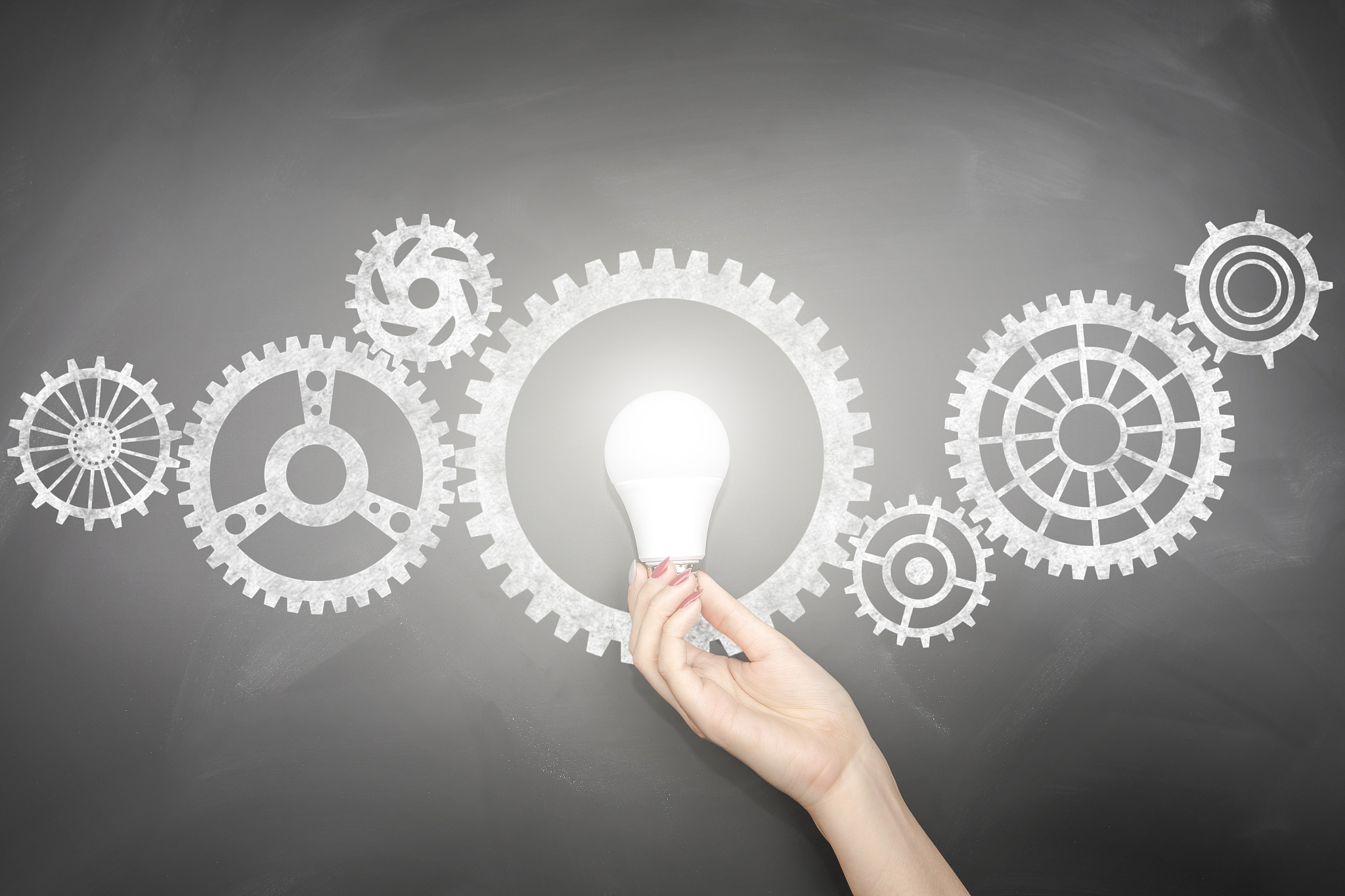 gears - light bulb hand idea blackboard