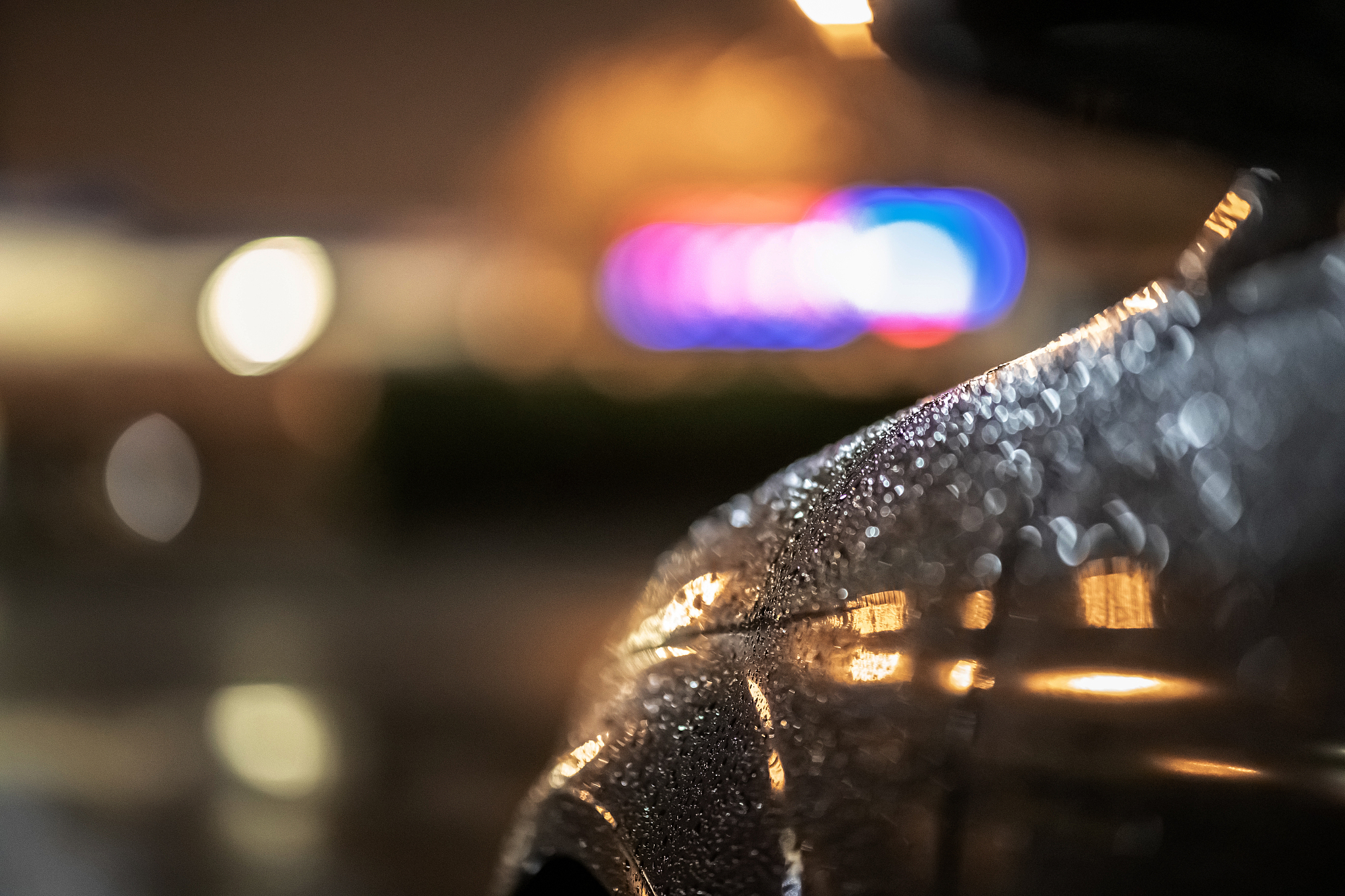 close up of a dramatic black car at night, waiting in street lig
