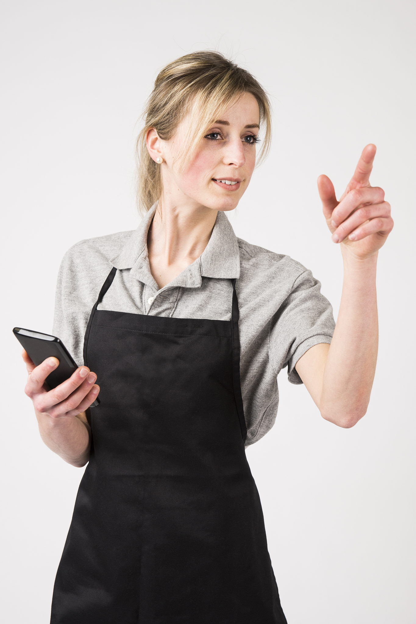employee in uniform, holding a smartphone and pointing