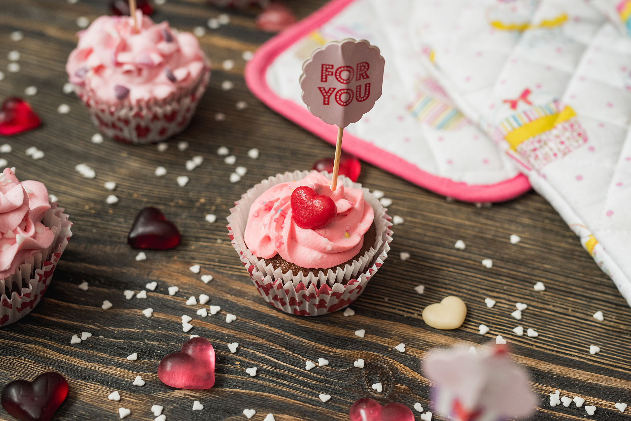 pink cupcakes on wooden table.