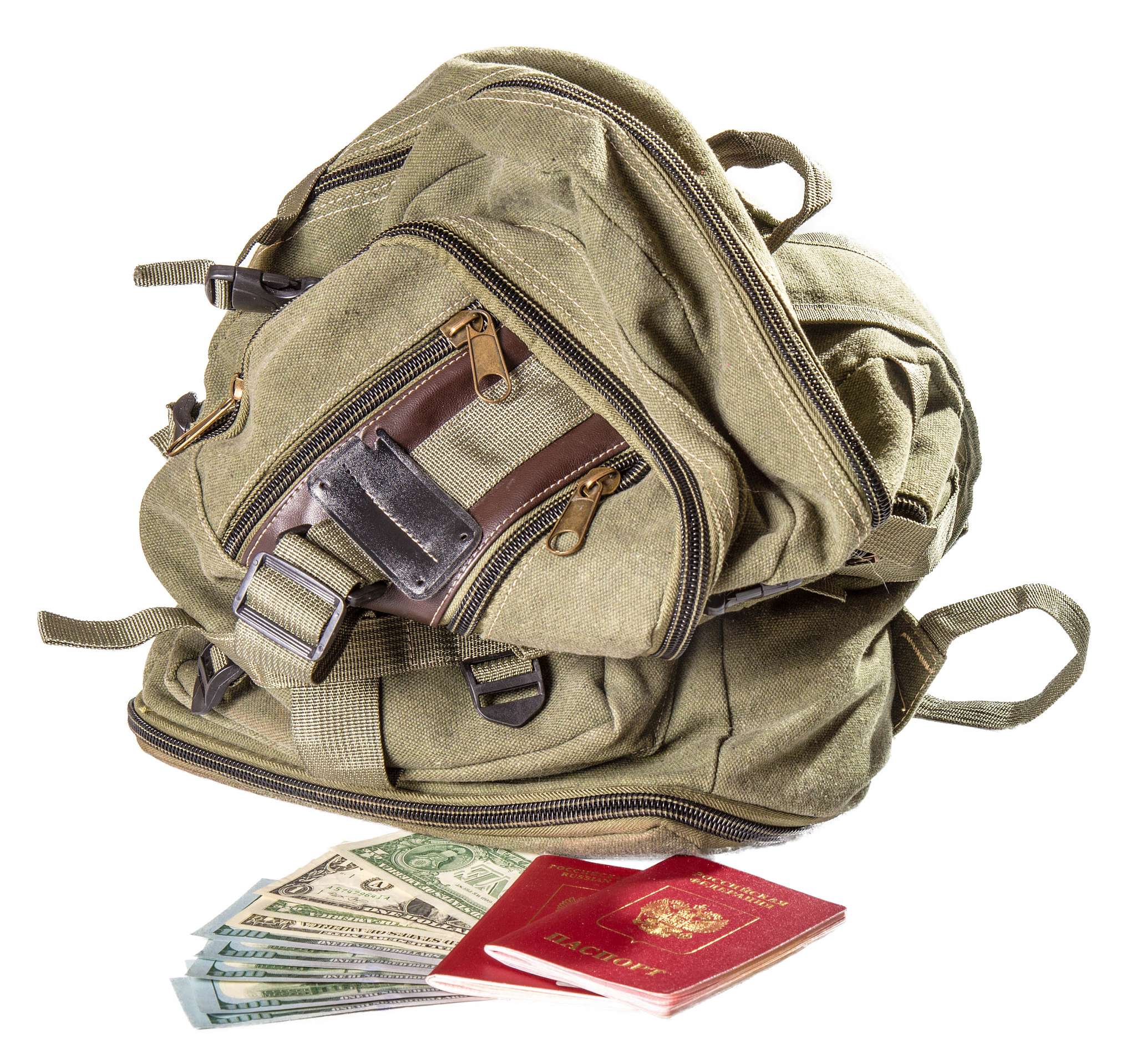 backpack of color khaki near the russian passports and dollars