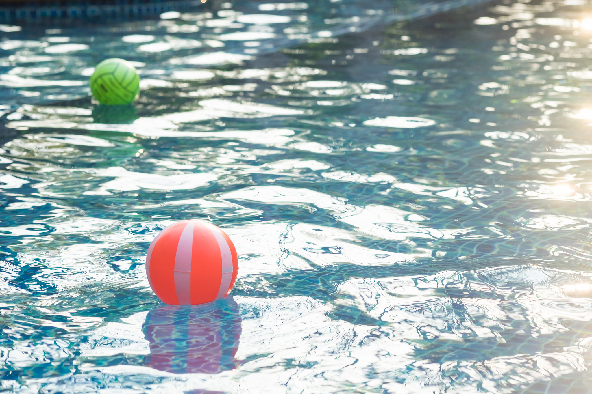 red beach ball in the swimming pool. concept of sport, vacation,
