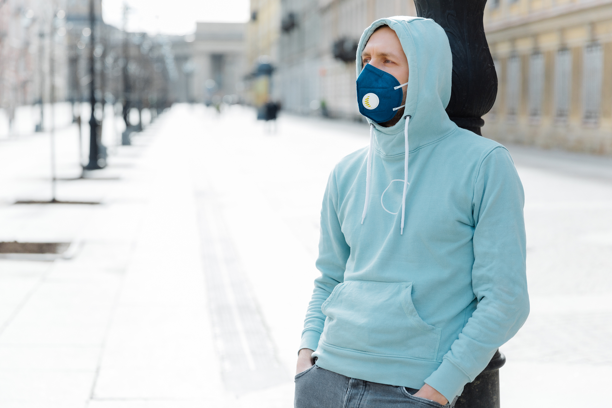 outdoor shot of hipster wears sweatshirt and respiratory mask, w