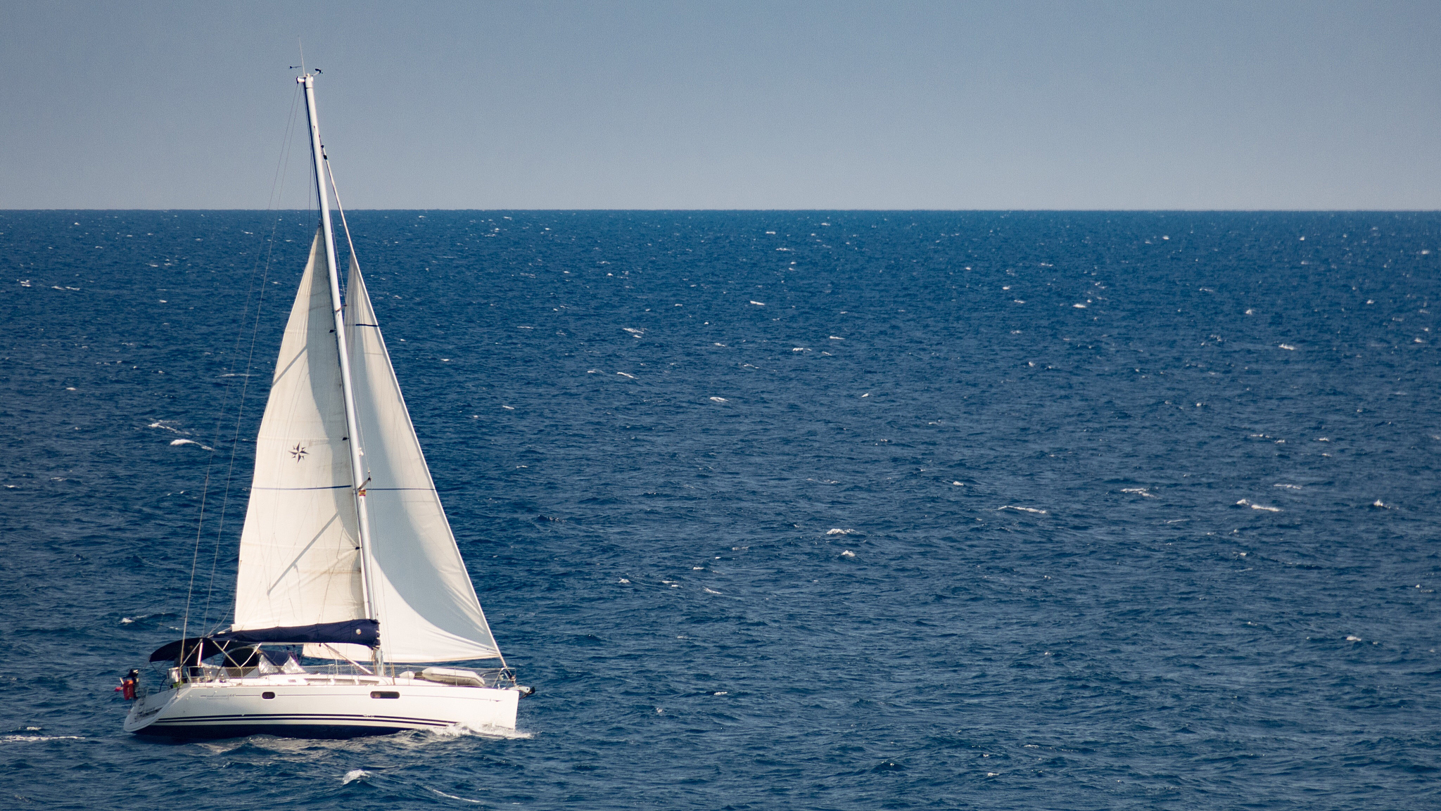 sailboat sailing in sea against clear sky