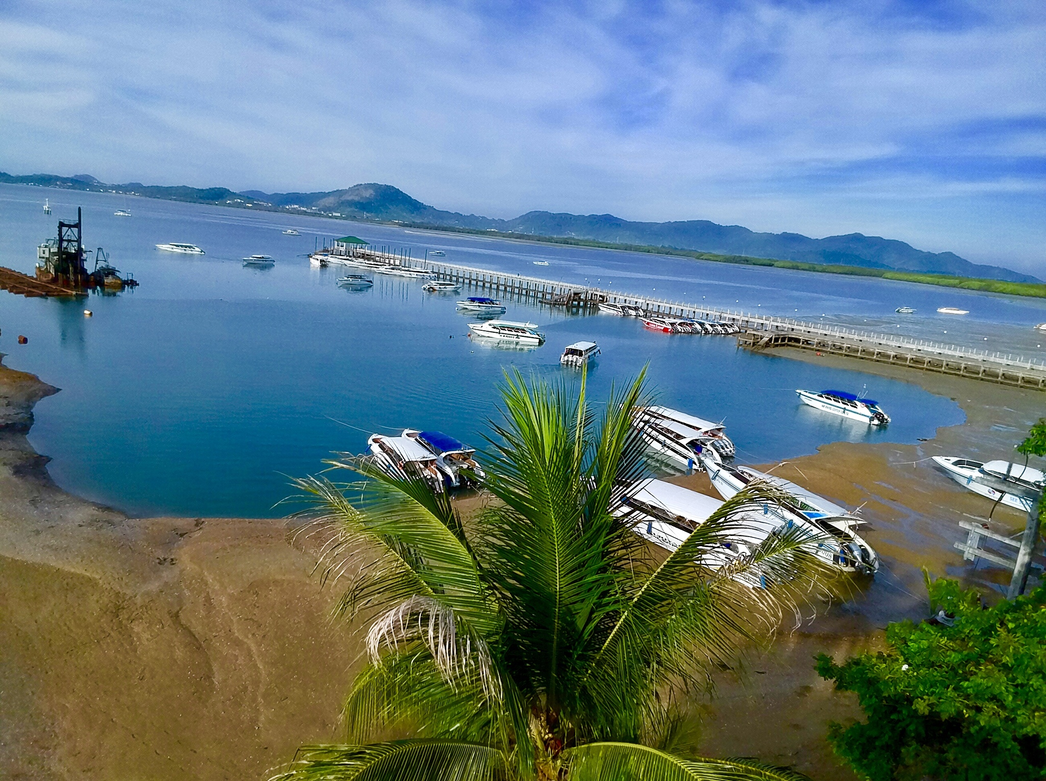 tallang phuket thailand turquoise waters lush green mountains