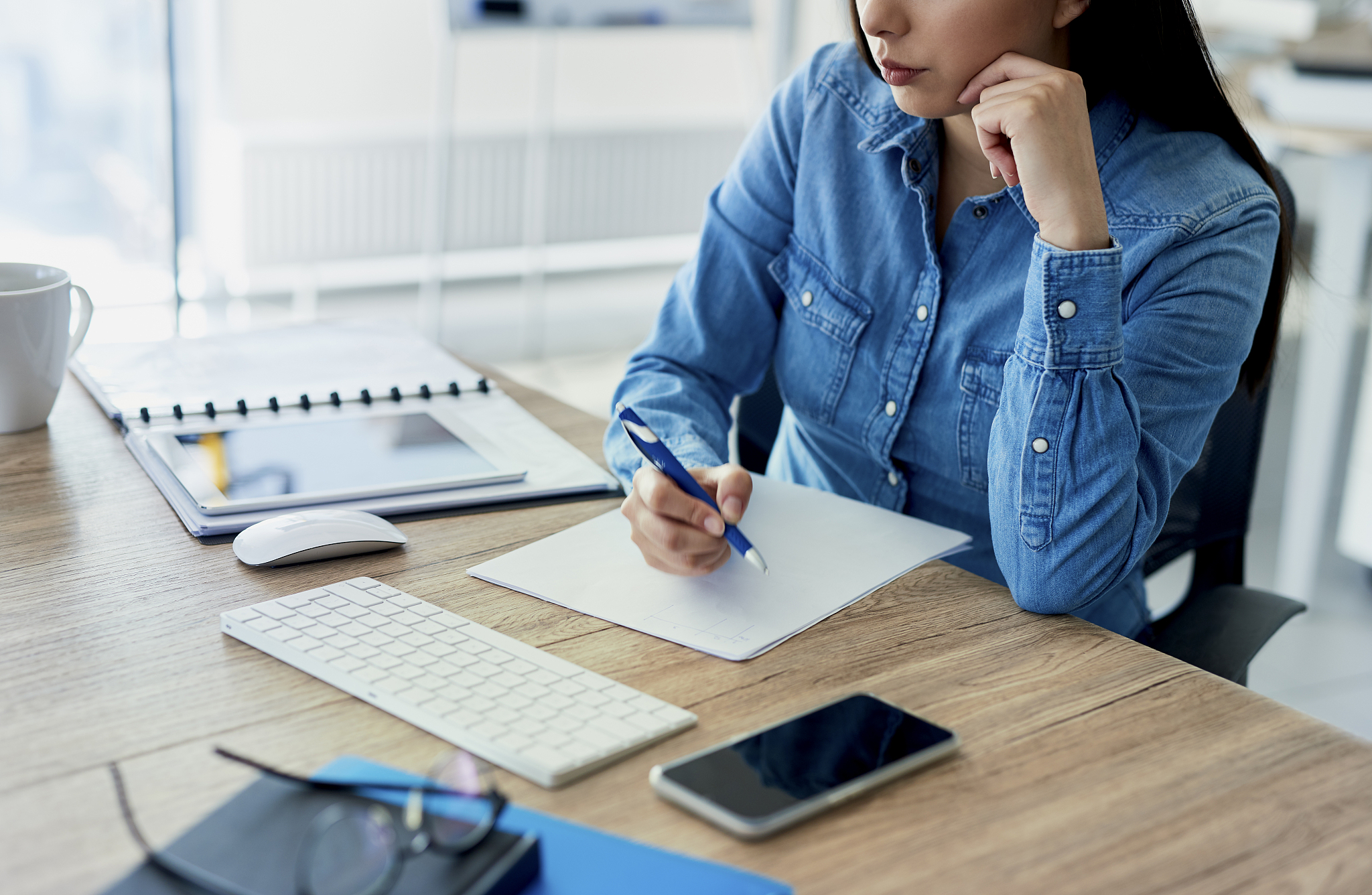lower section of woman working at the desk