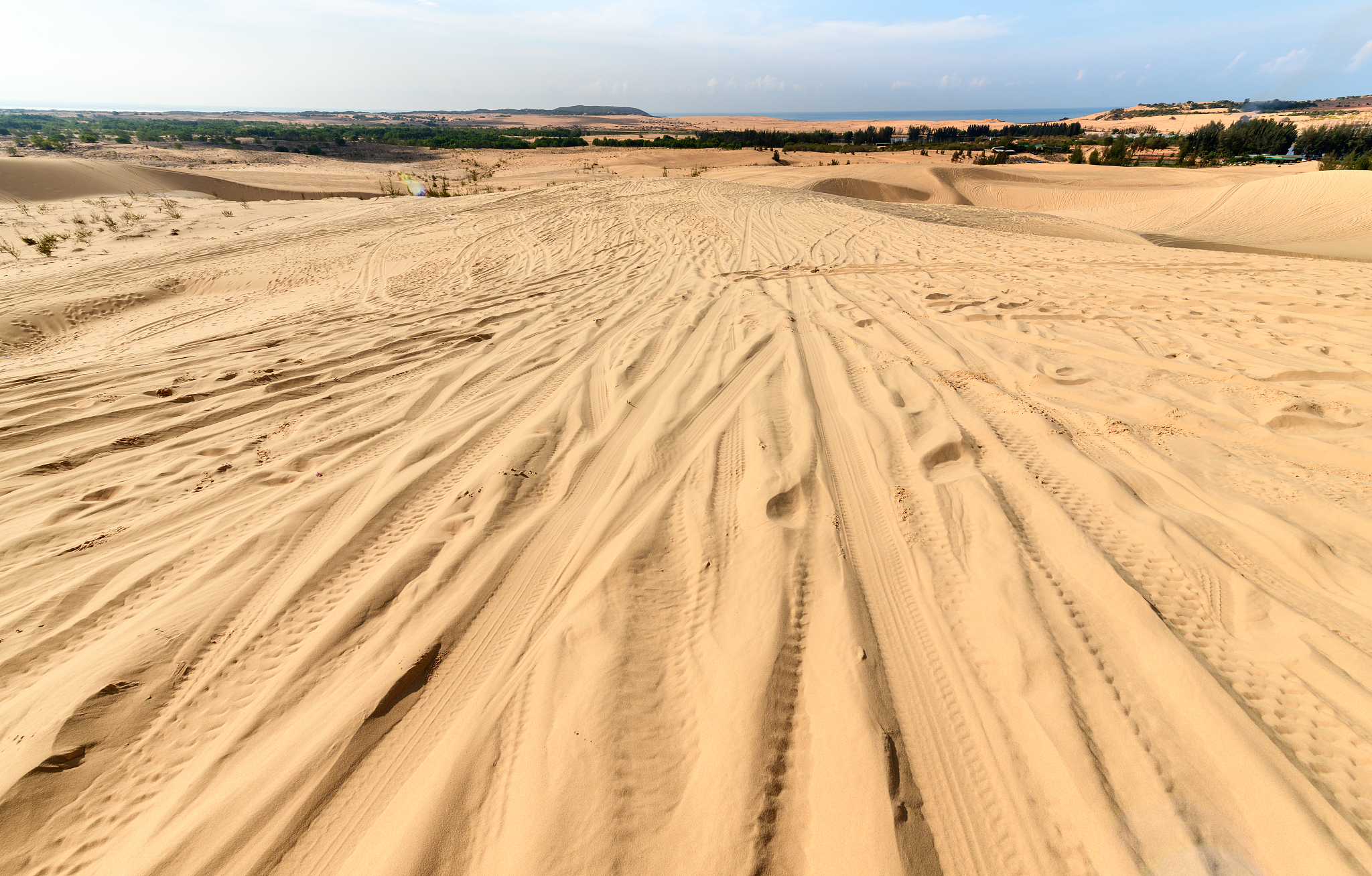 white sand dunes with white cloudy and blue sky