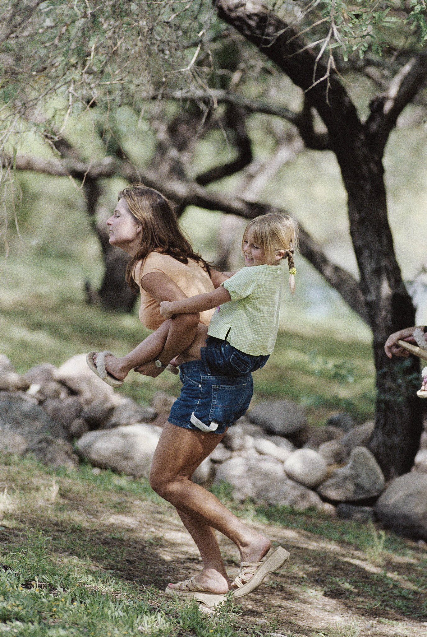 woman carrying daughter piggyback