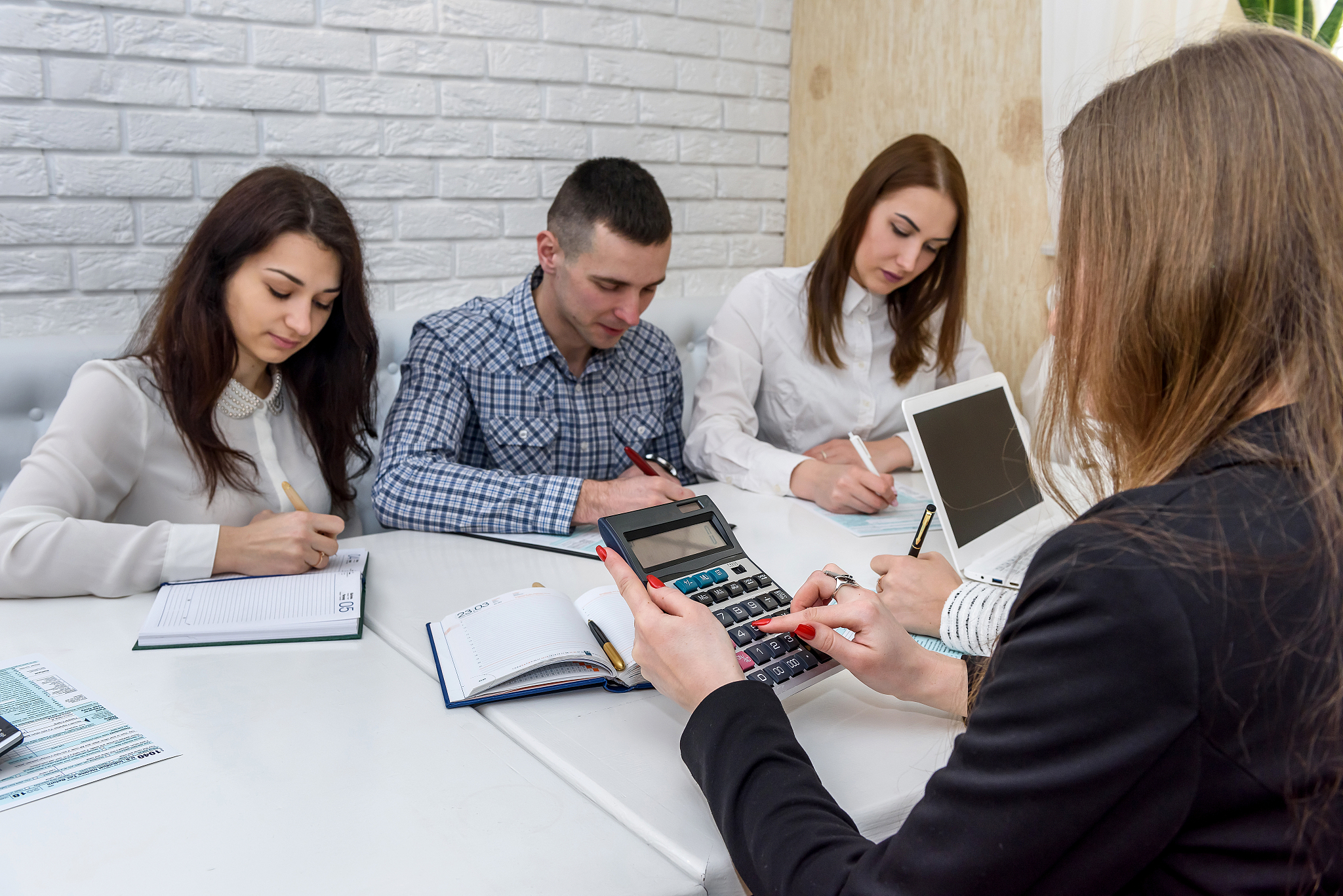 group of people working with 1040 tax form