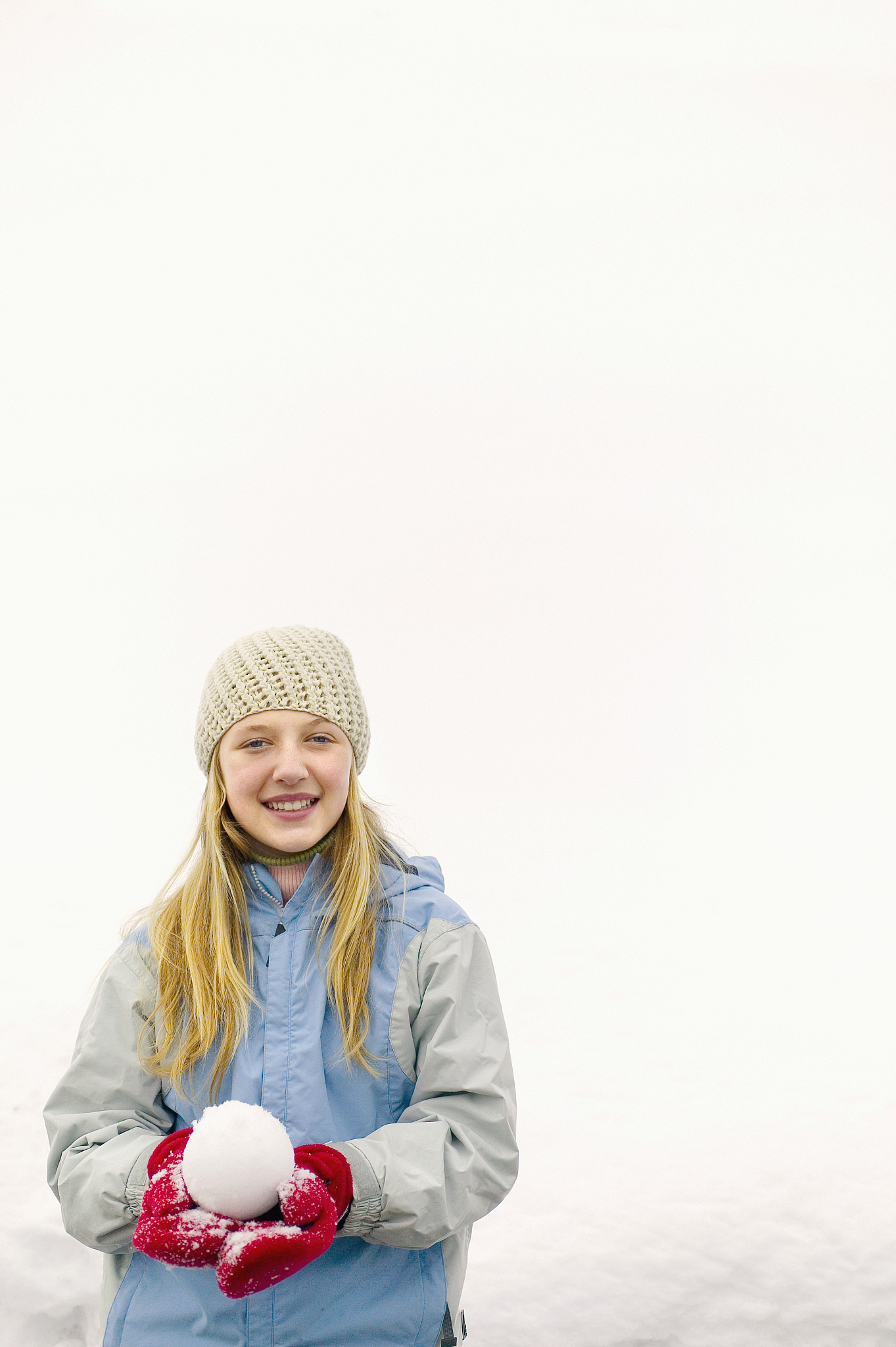 smiling girl holding snowball