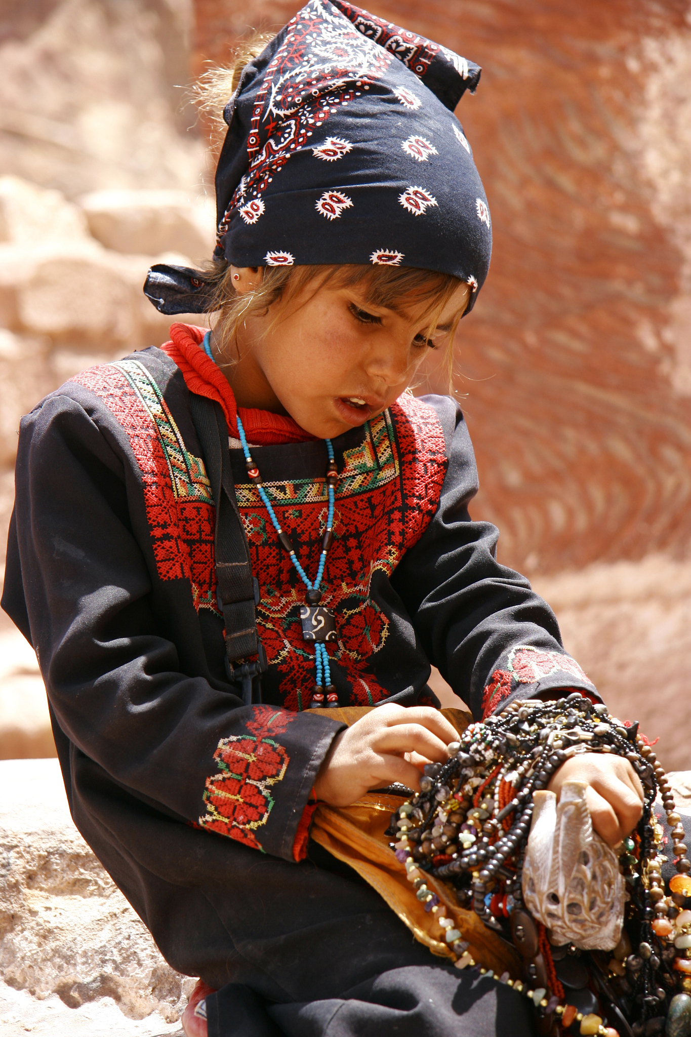 young asian girl selling beads