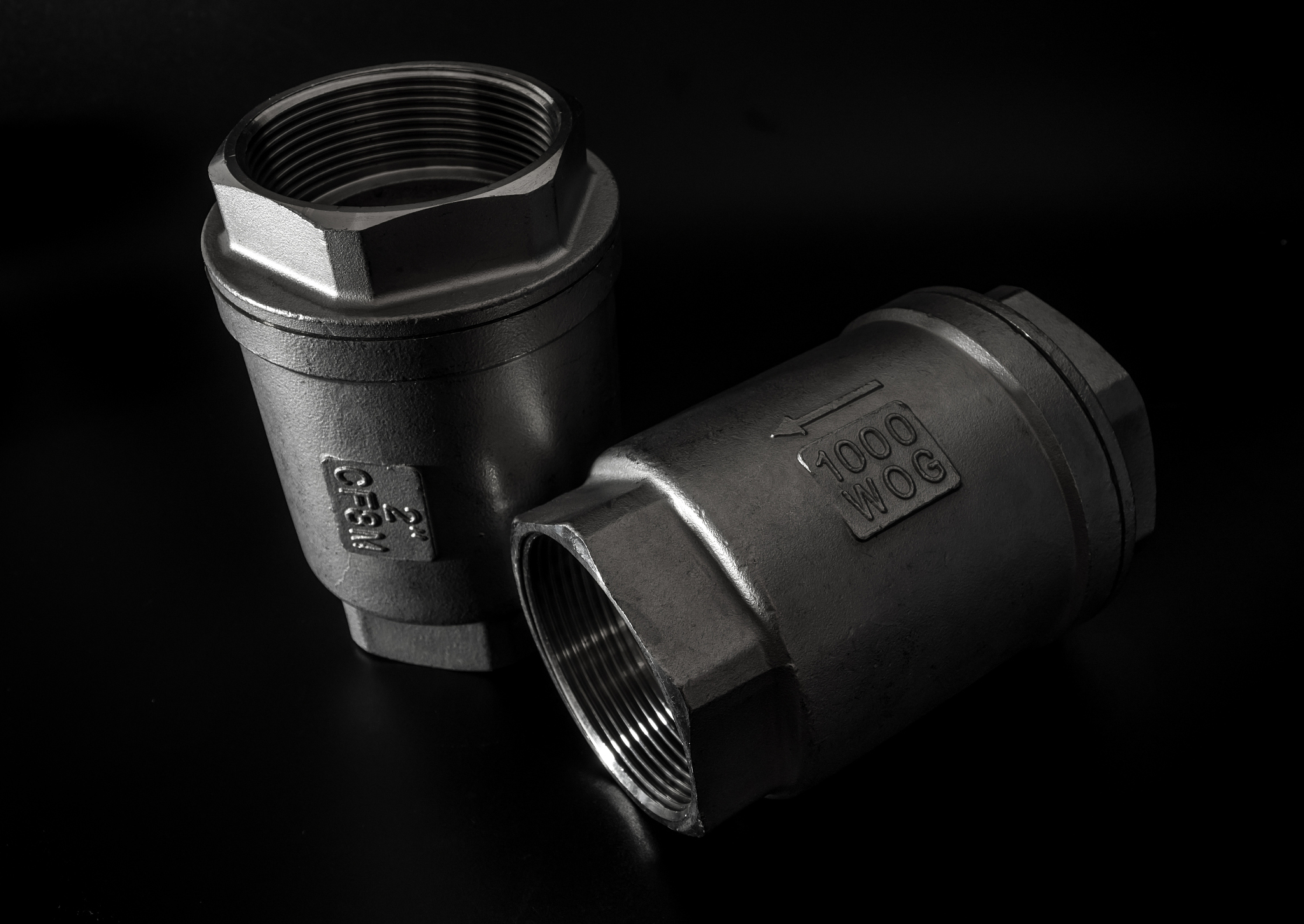 stainless steel check valve on black background