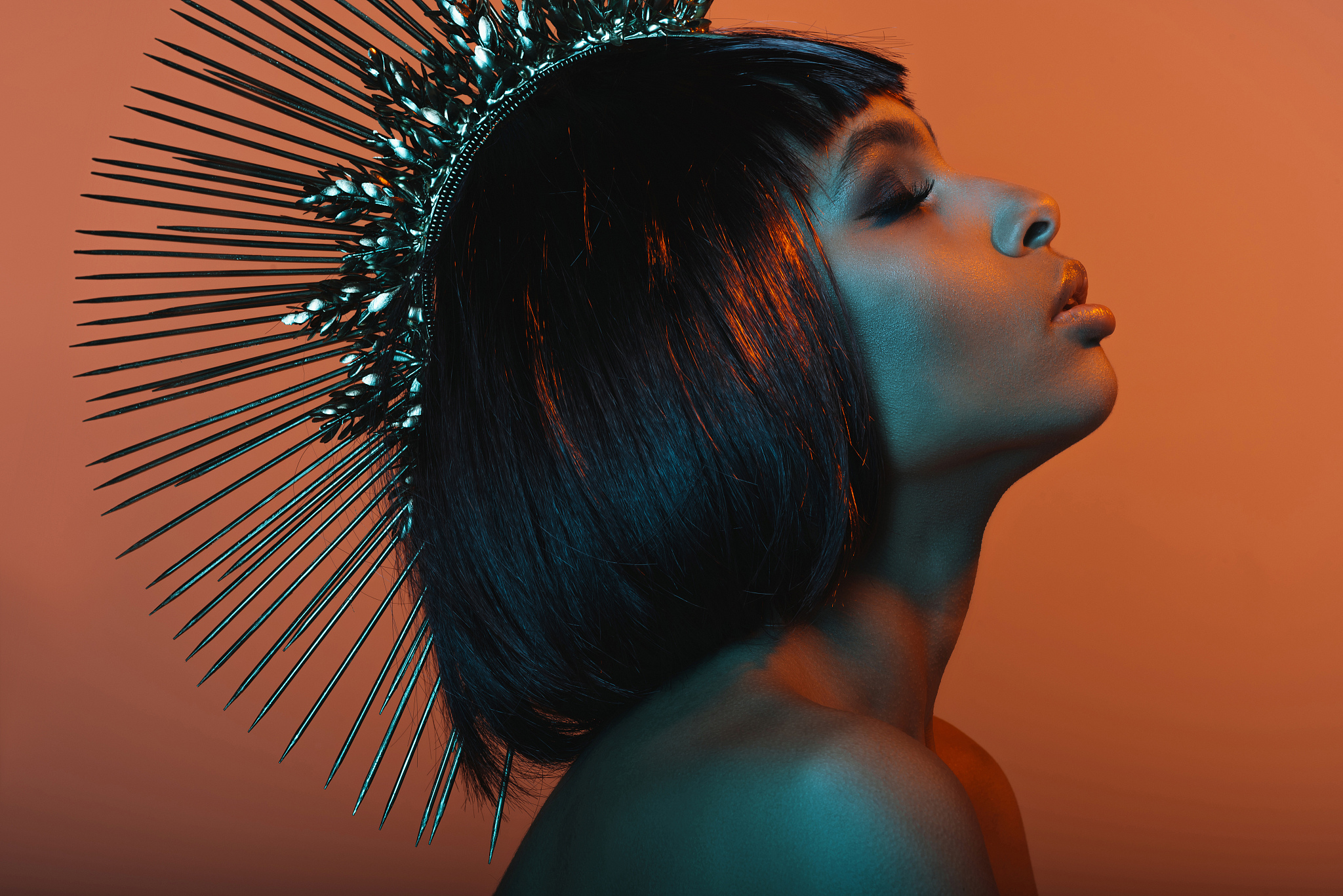 side view of stylish african american girl in headpiece with eye