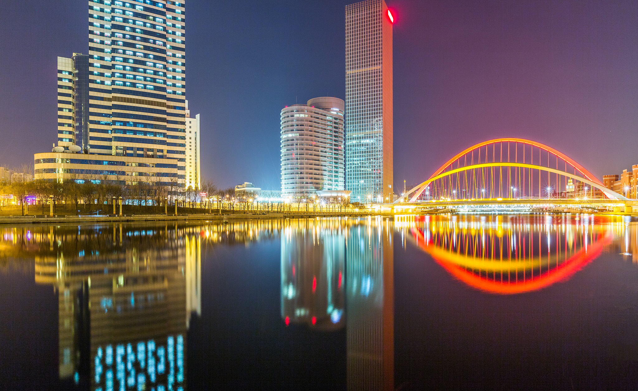river and modern buildings against sky