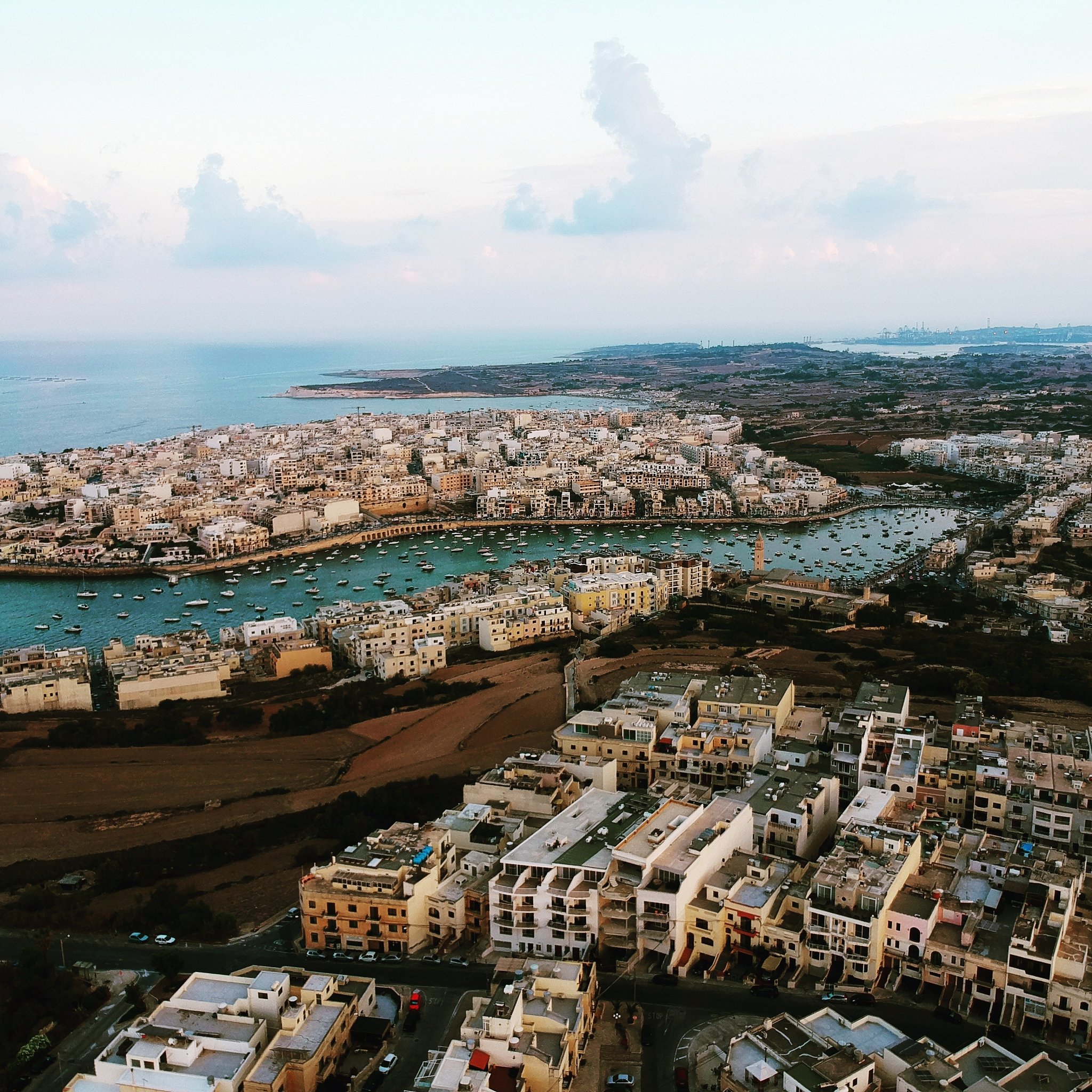 high angle view of townscape by sea against sky