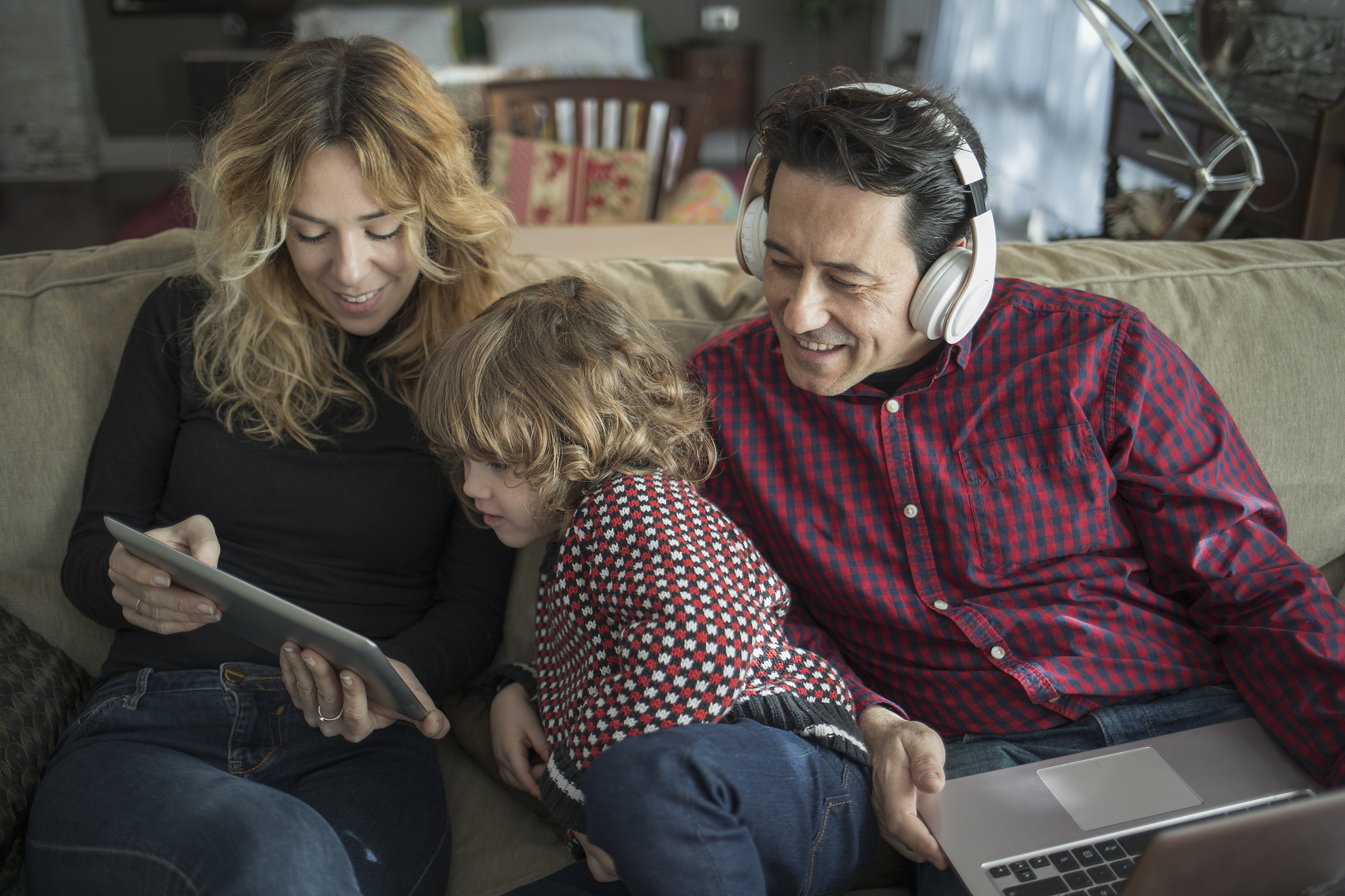 family using digital tablet at home