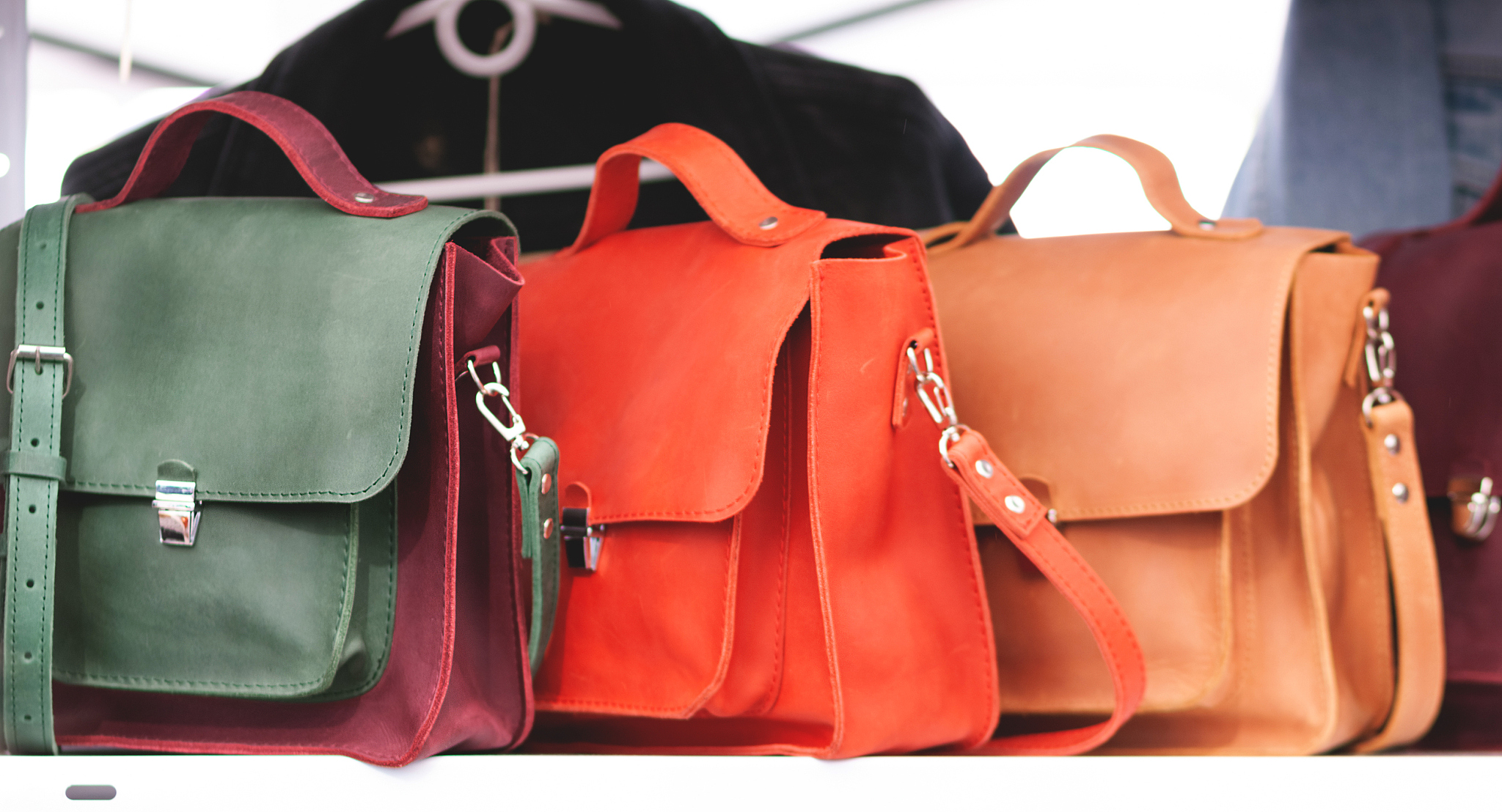 three women's leather handbags