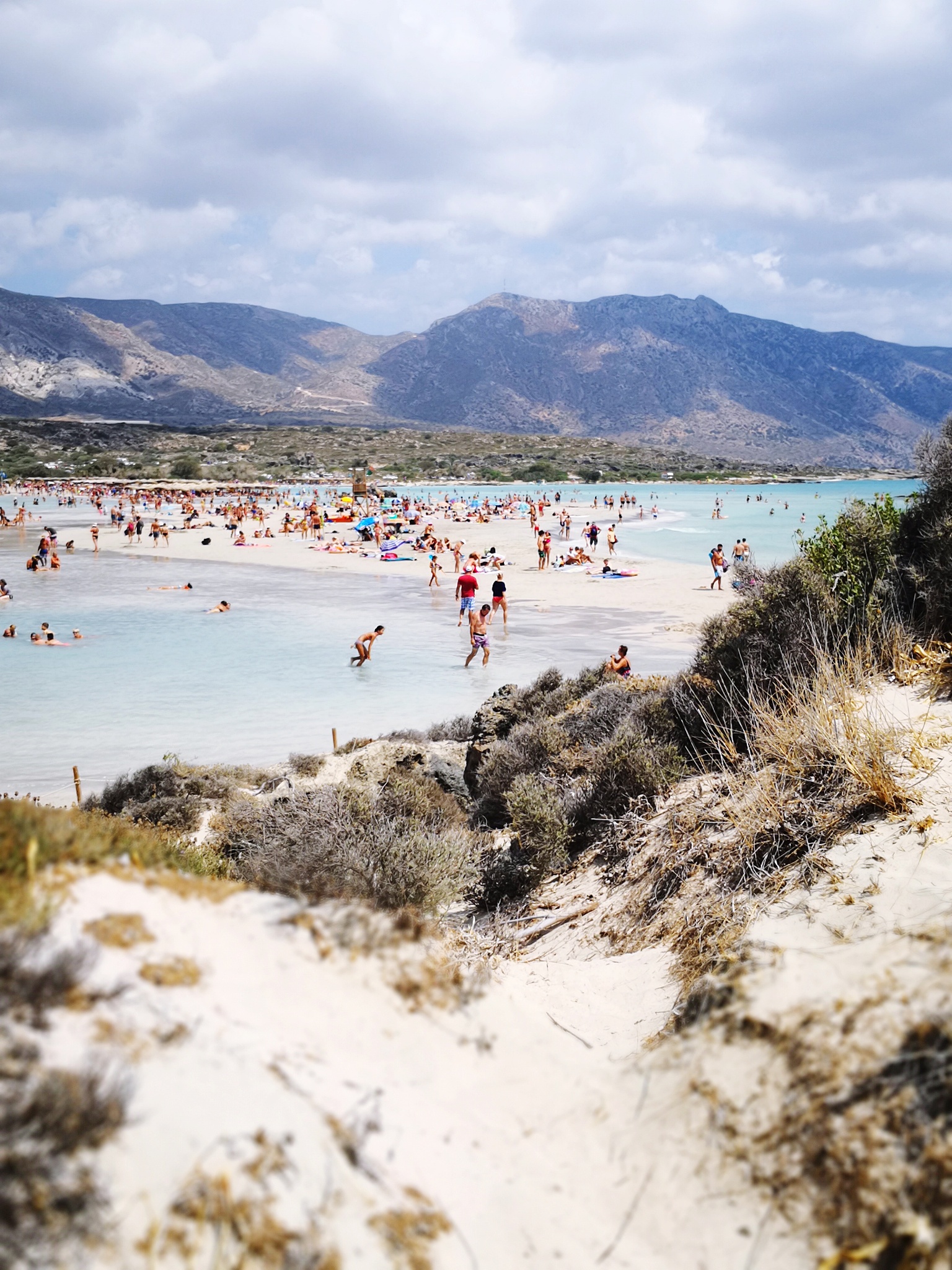 people at beach against sky