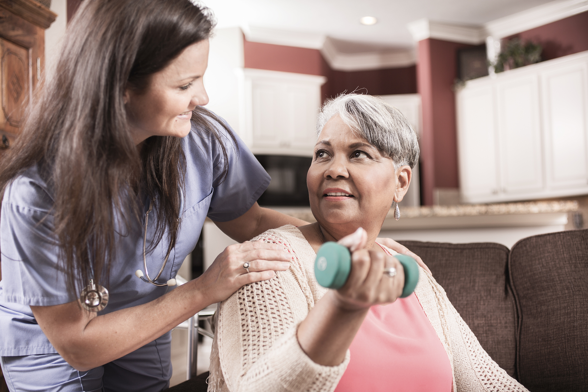 home healthcare nurse, physical therapy with senior adult woman.