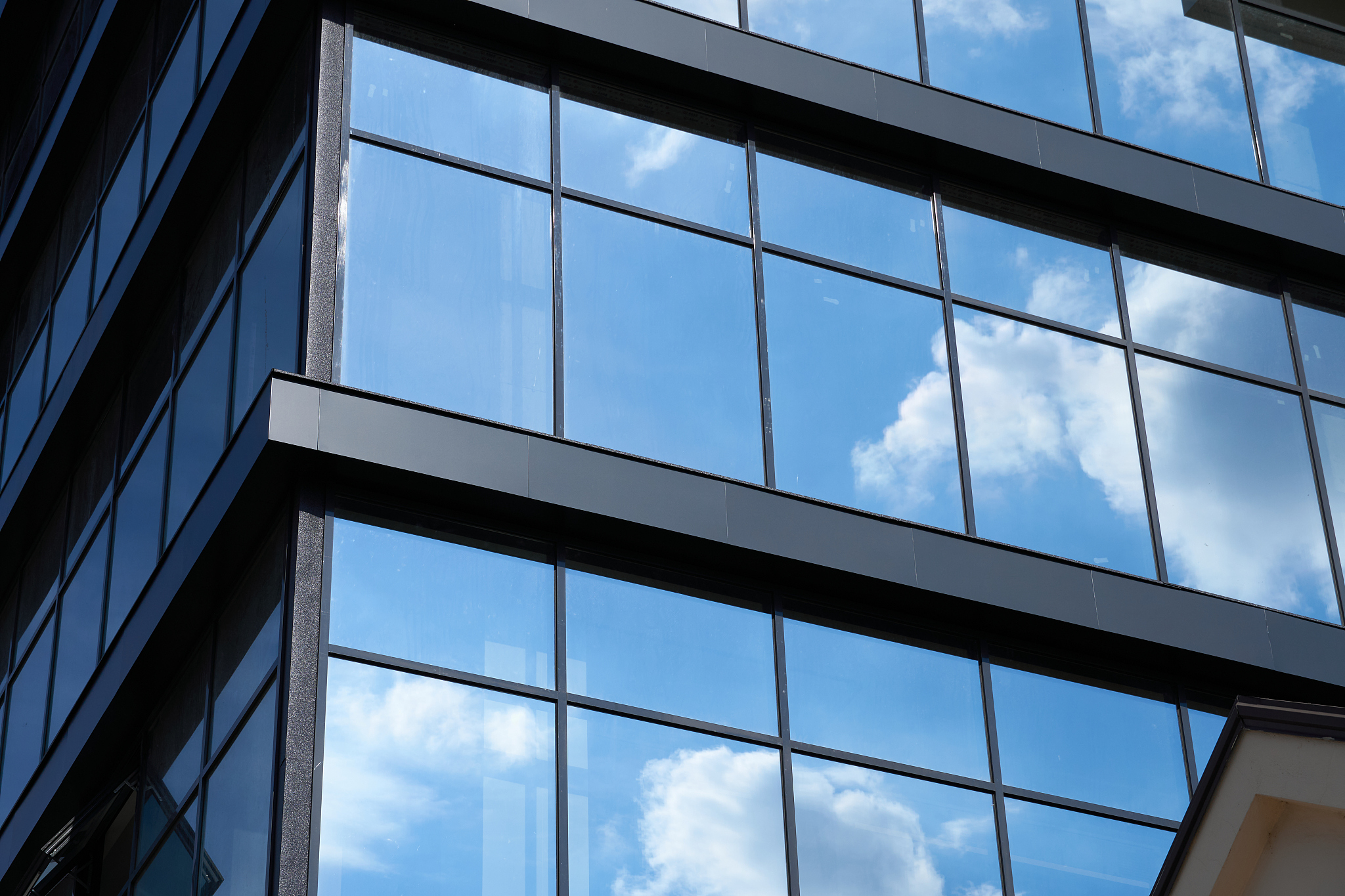 facade of a modern building on a bright sunny day, blue sky and 