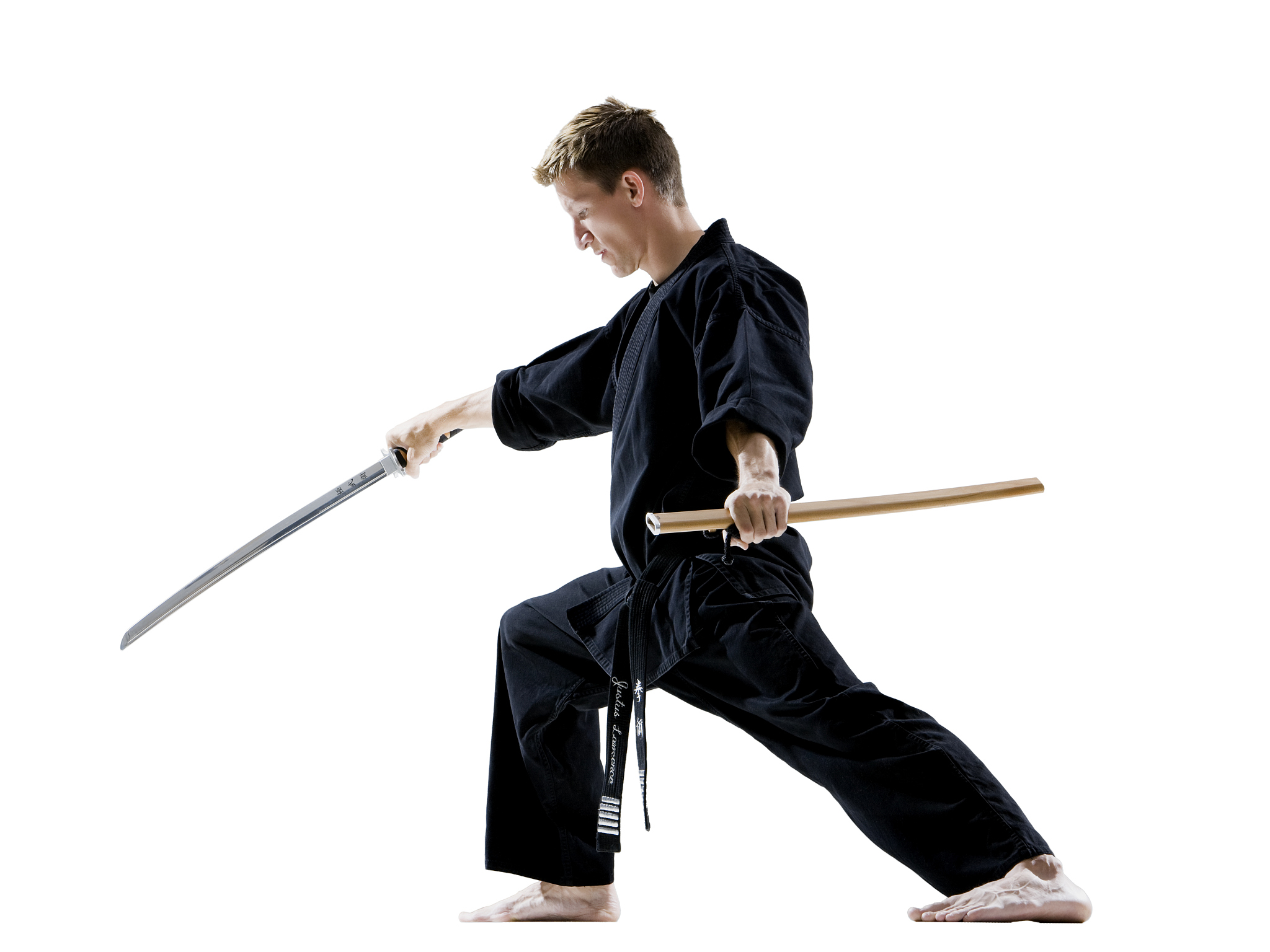 man in a black karate gi practicing martial arts