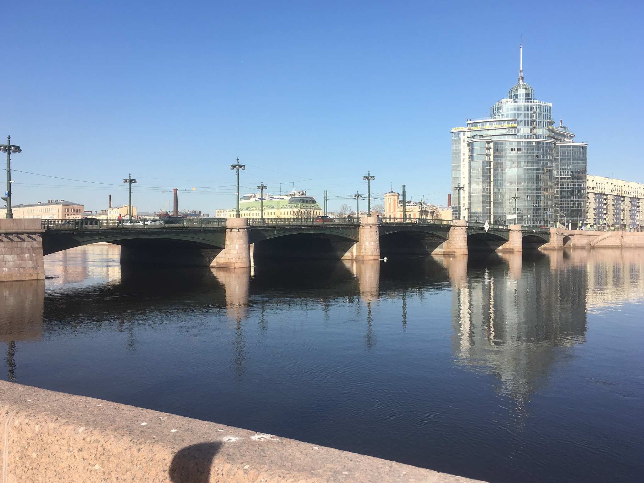 bridge over river in city against clear sky
