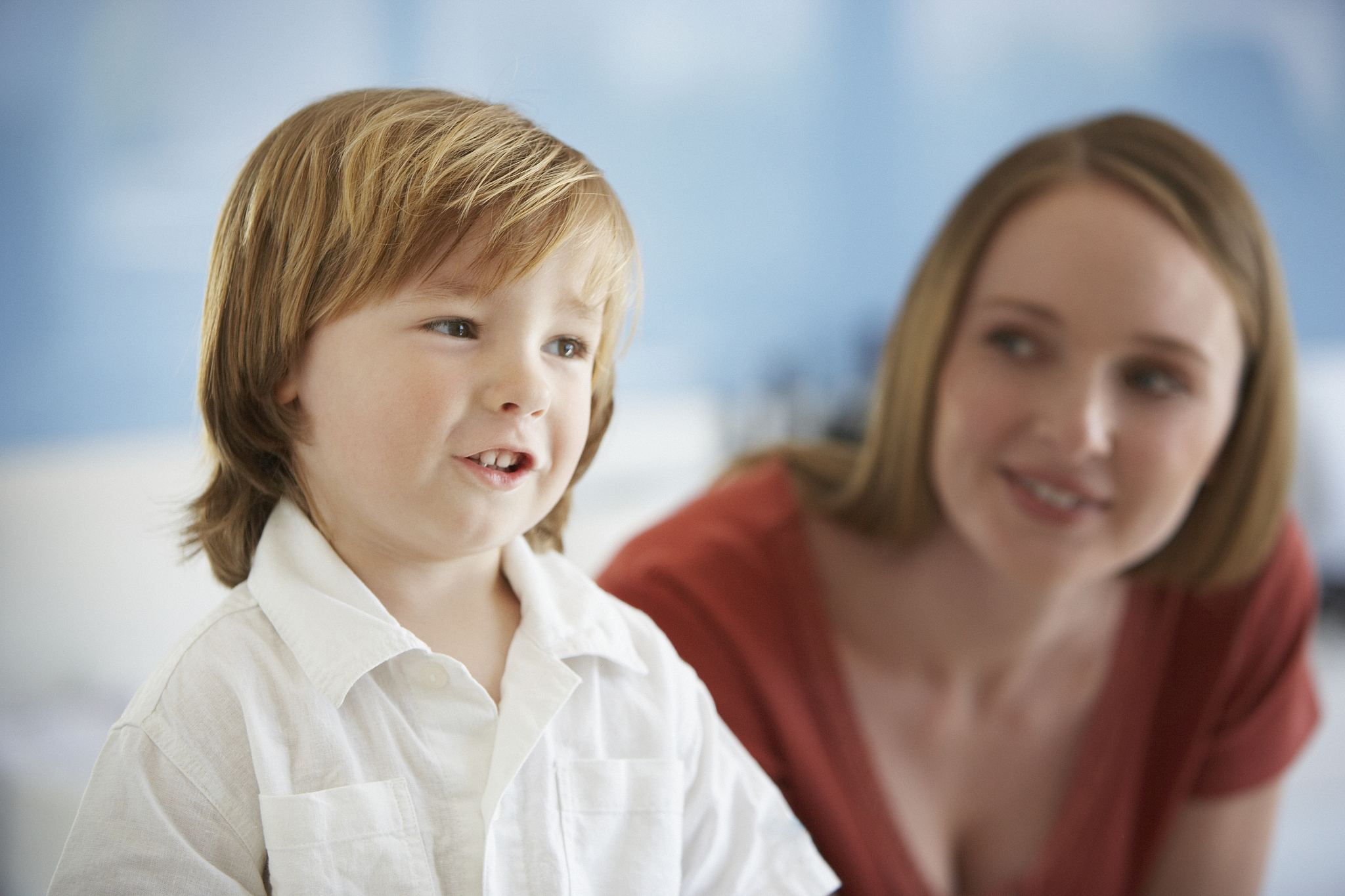 boy (2-4) with mother in background (focus on boy)