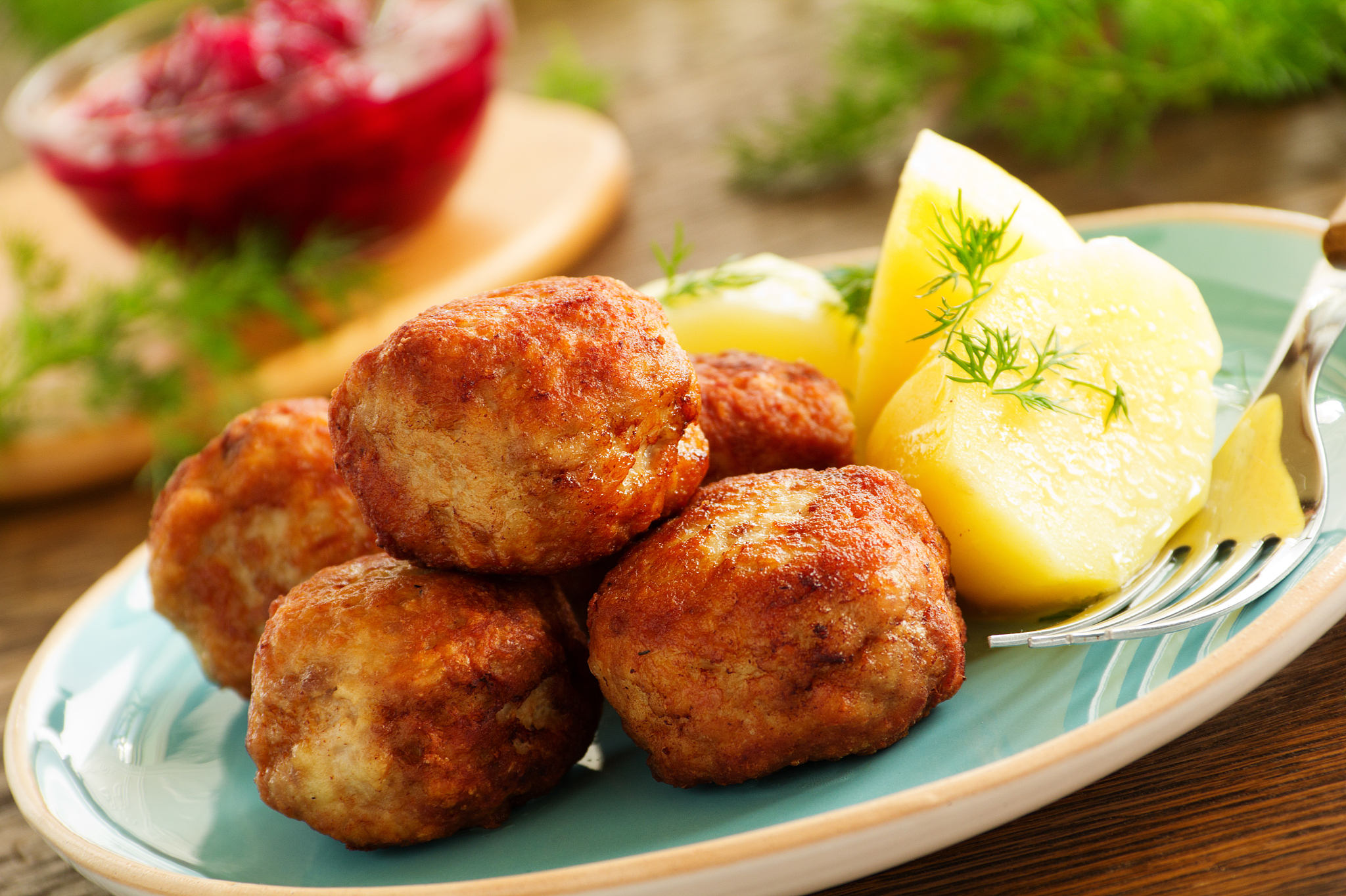 hot meatballs with boiled potatoes and cranberry sauce ..