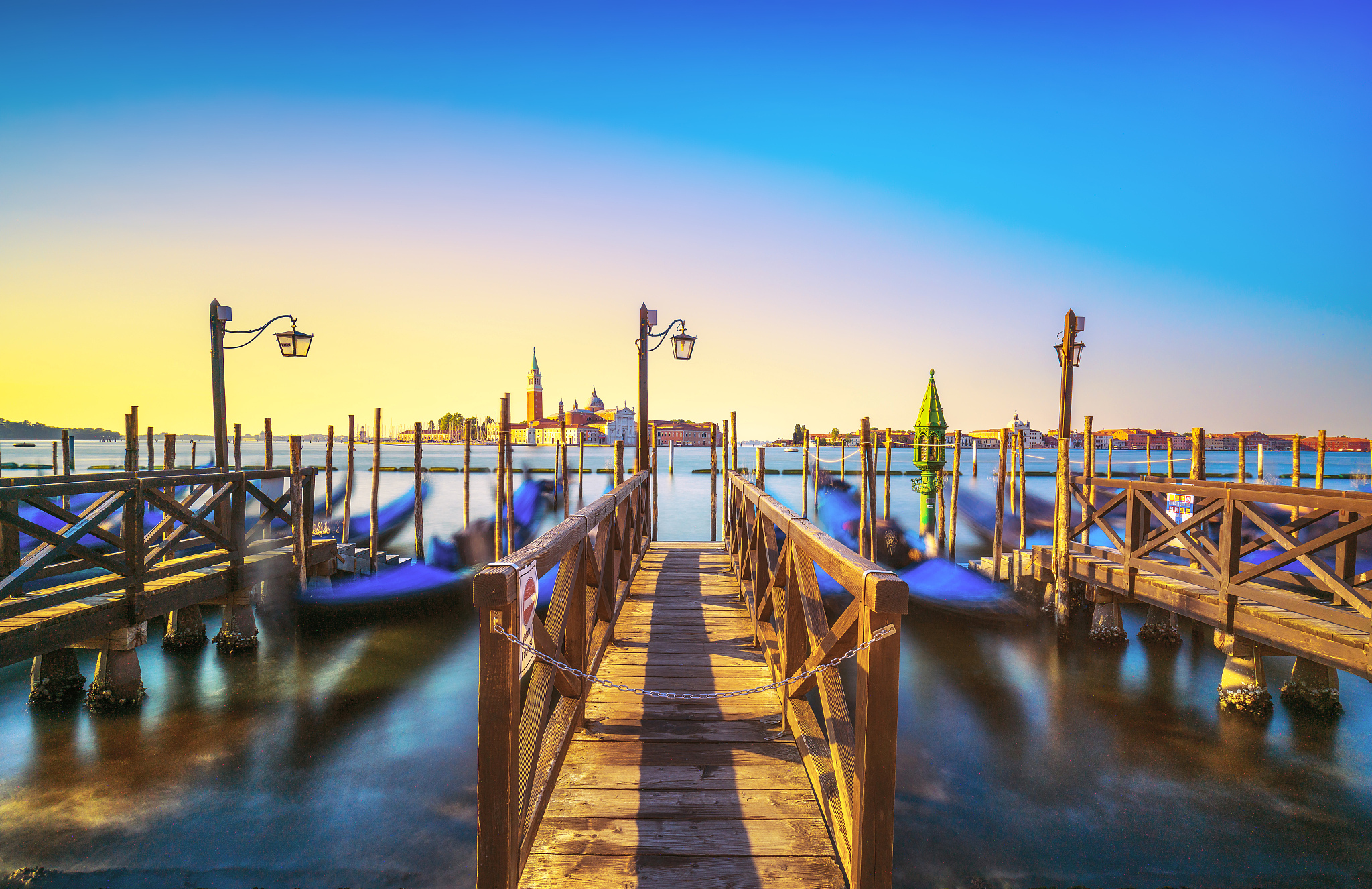 venice lagoon, san giorgio church, gondolas and poles. italy