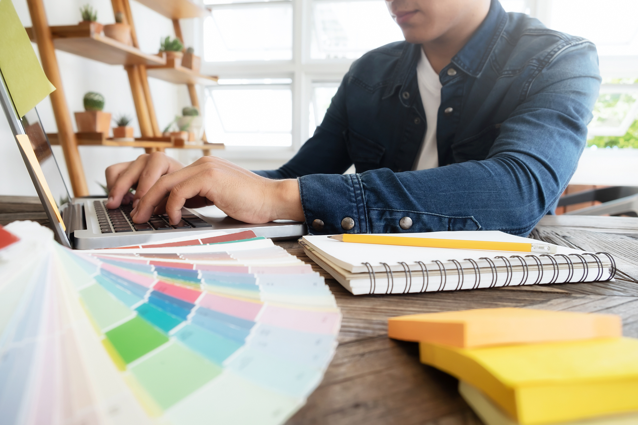 freelance photo editor, artist, graphic designer working at desk