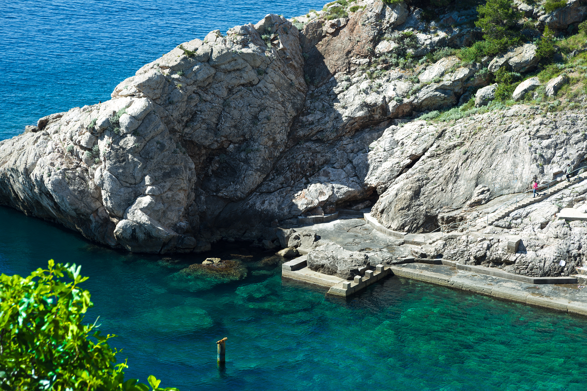 scenic view of sea against rock formation