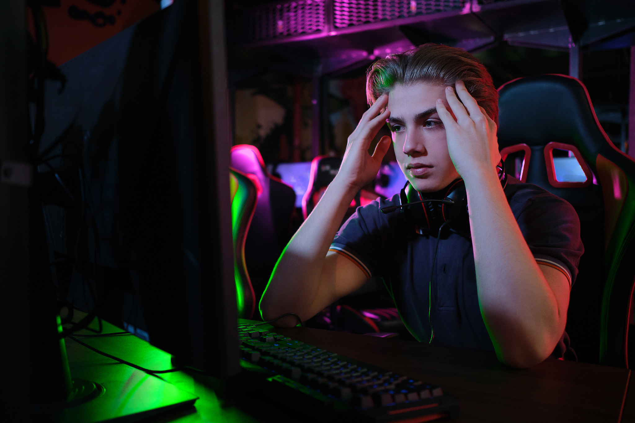 professional young caucasian gamer playing online on his pc. he 