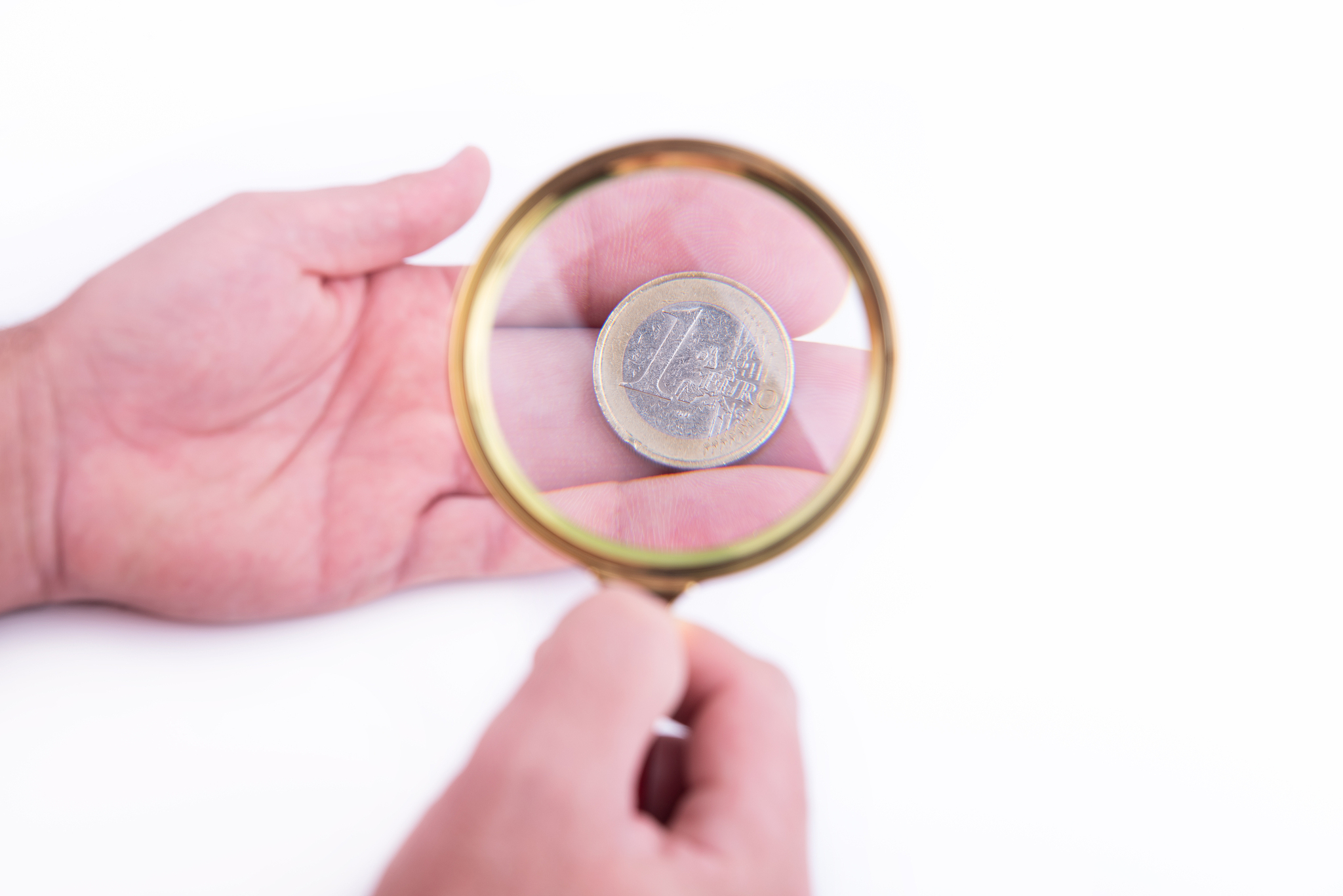 hand with euro and magnified glass